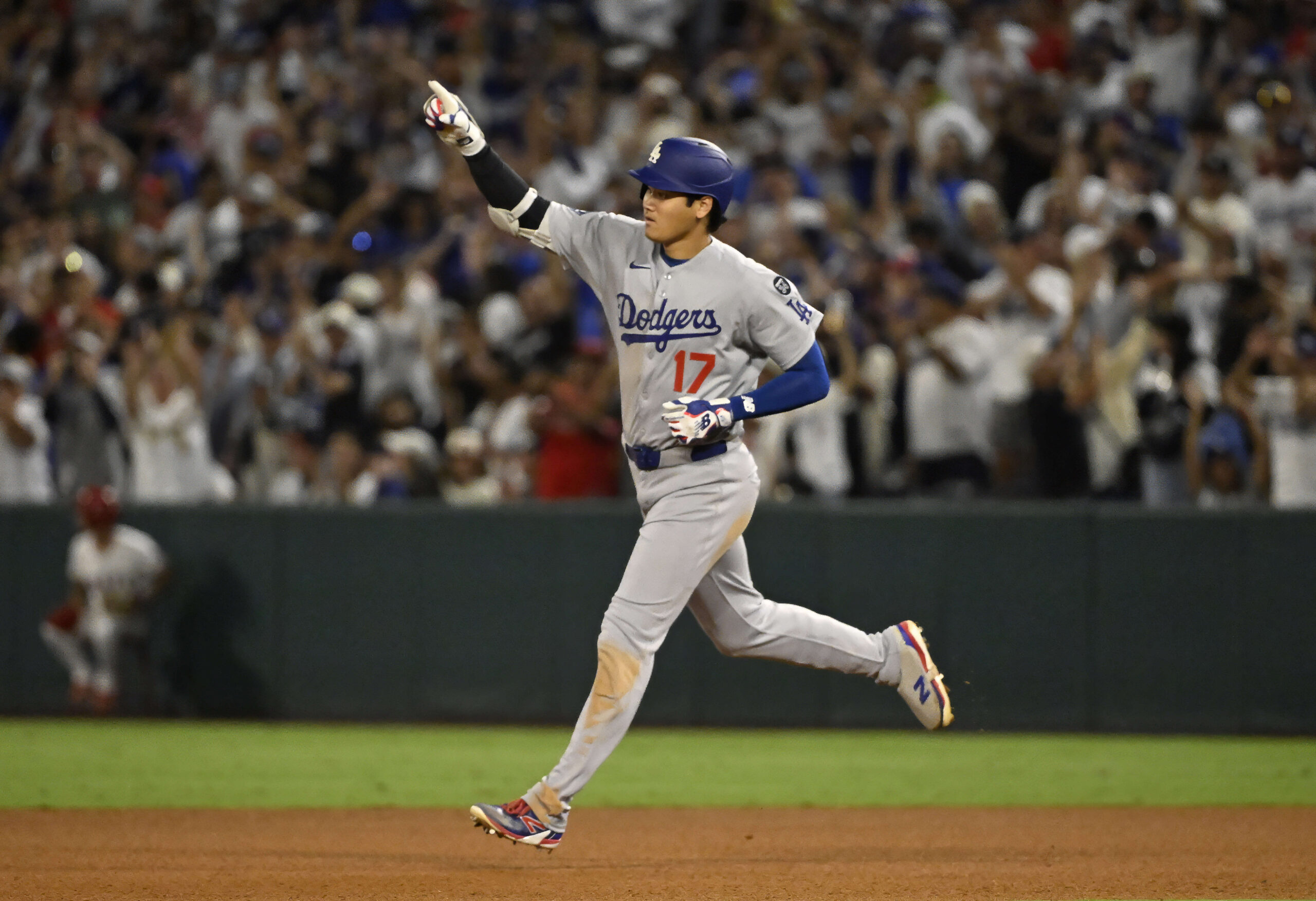 Dodgers star Shohei Ohtani runs the bases after hitting a...