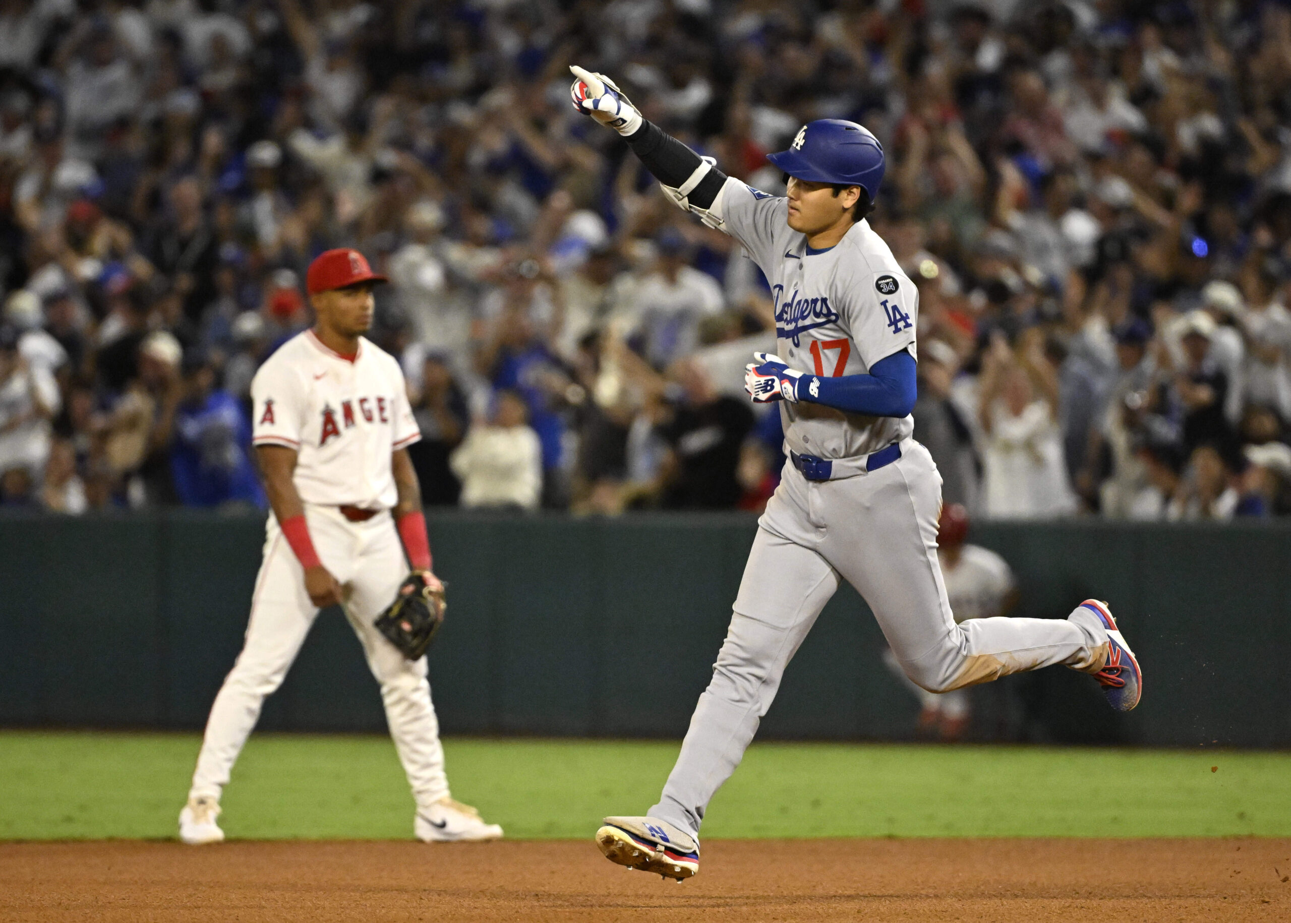Dodgers star Shohei Ohtani runs the bases after hitting a...