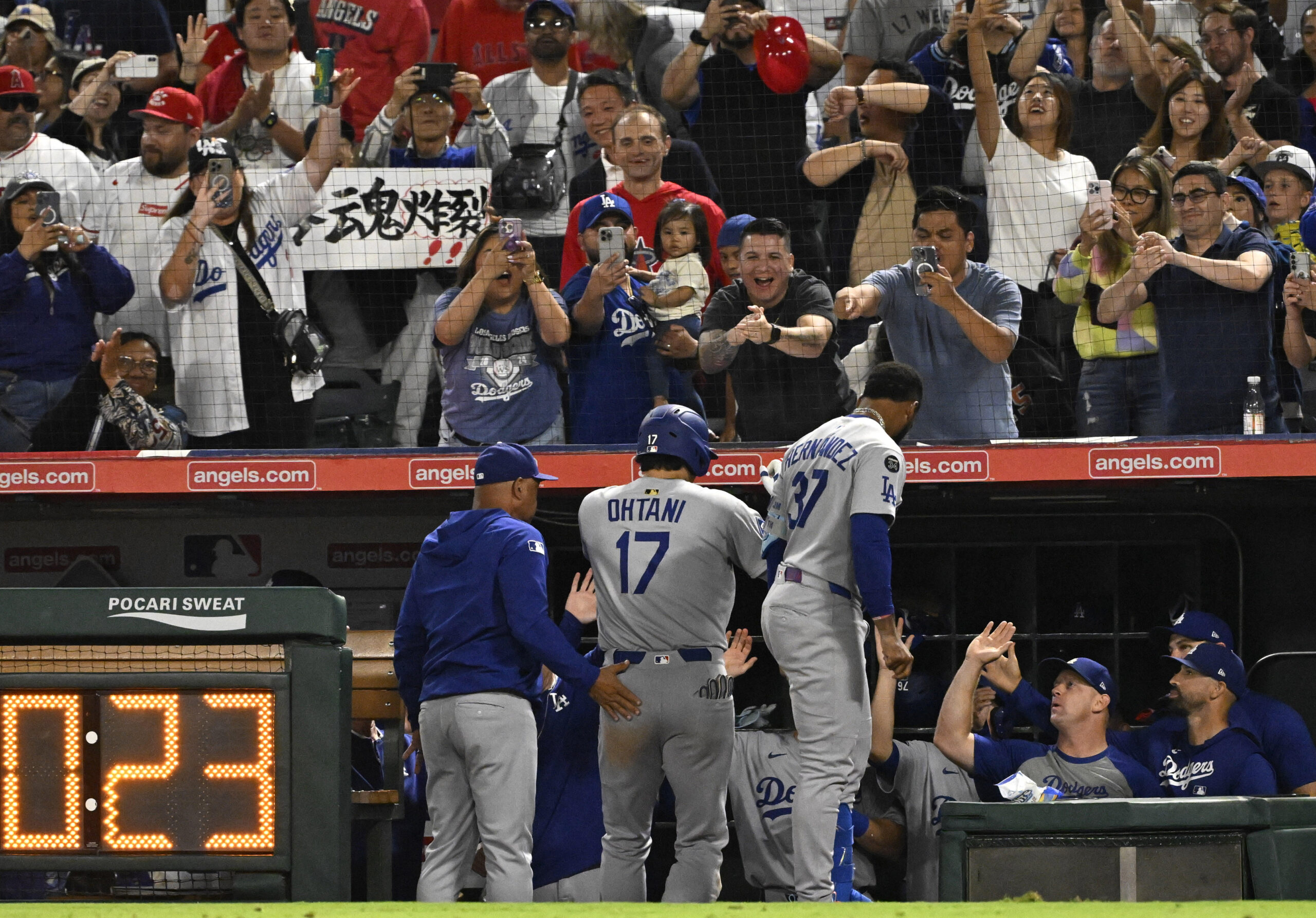 Dodgers star Shohei Ohtani (17) celebrates as he returns to...
