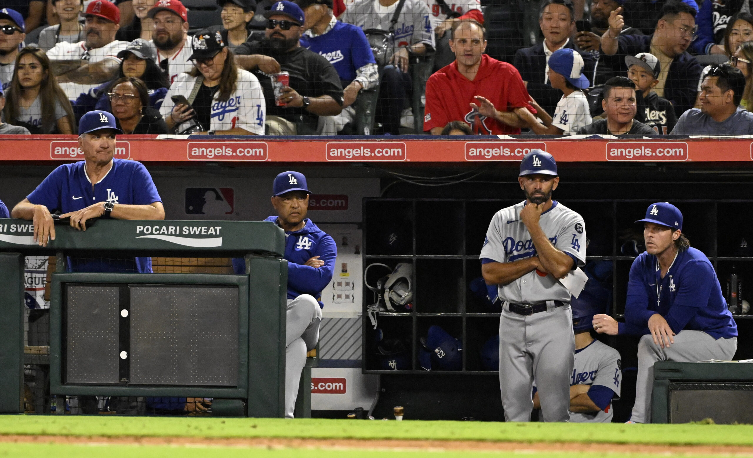 Dodgers manager Dave Roberts, second from left, and the coaching...