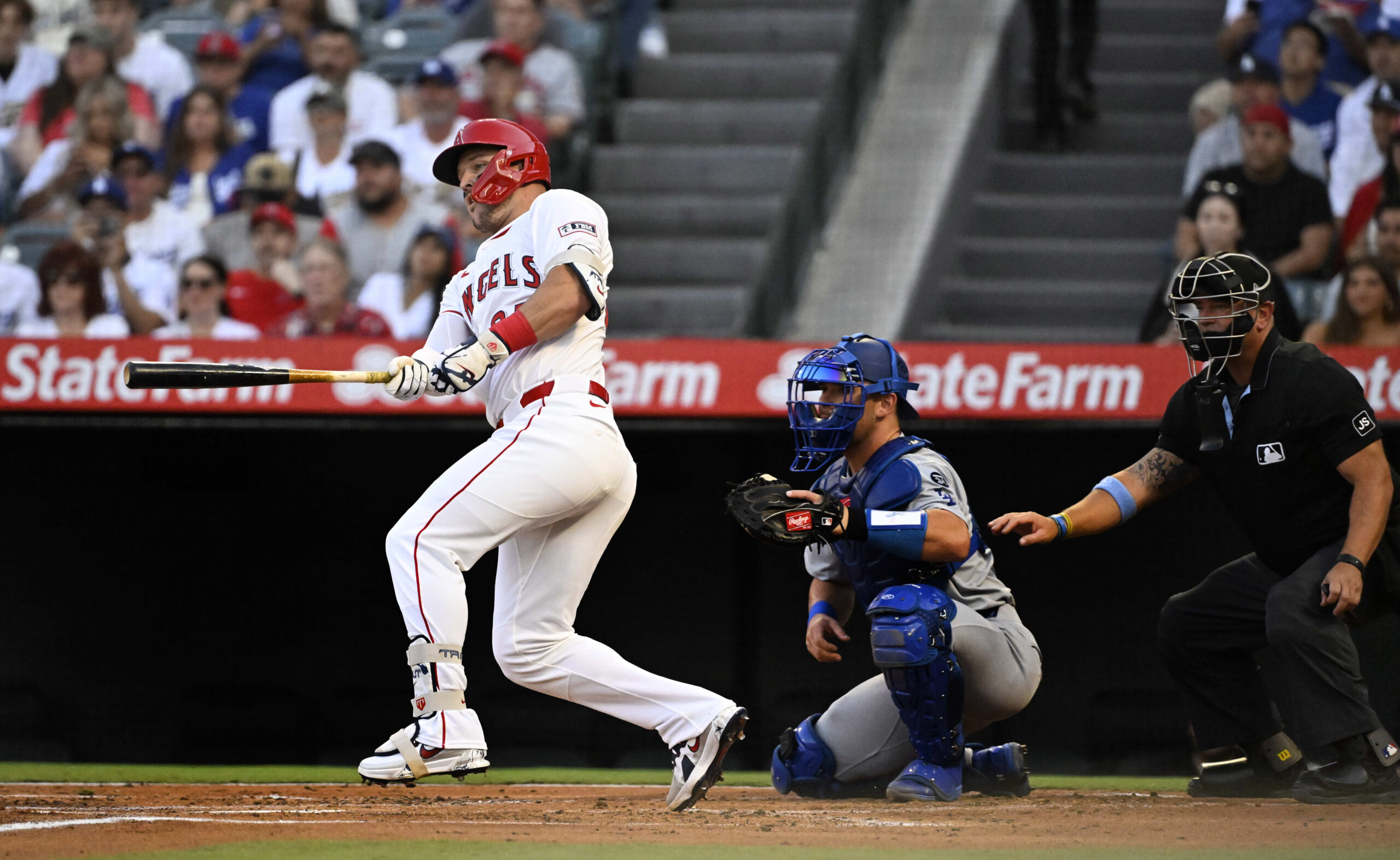 Angels star Mike Trout hits a single during the first...