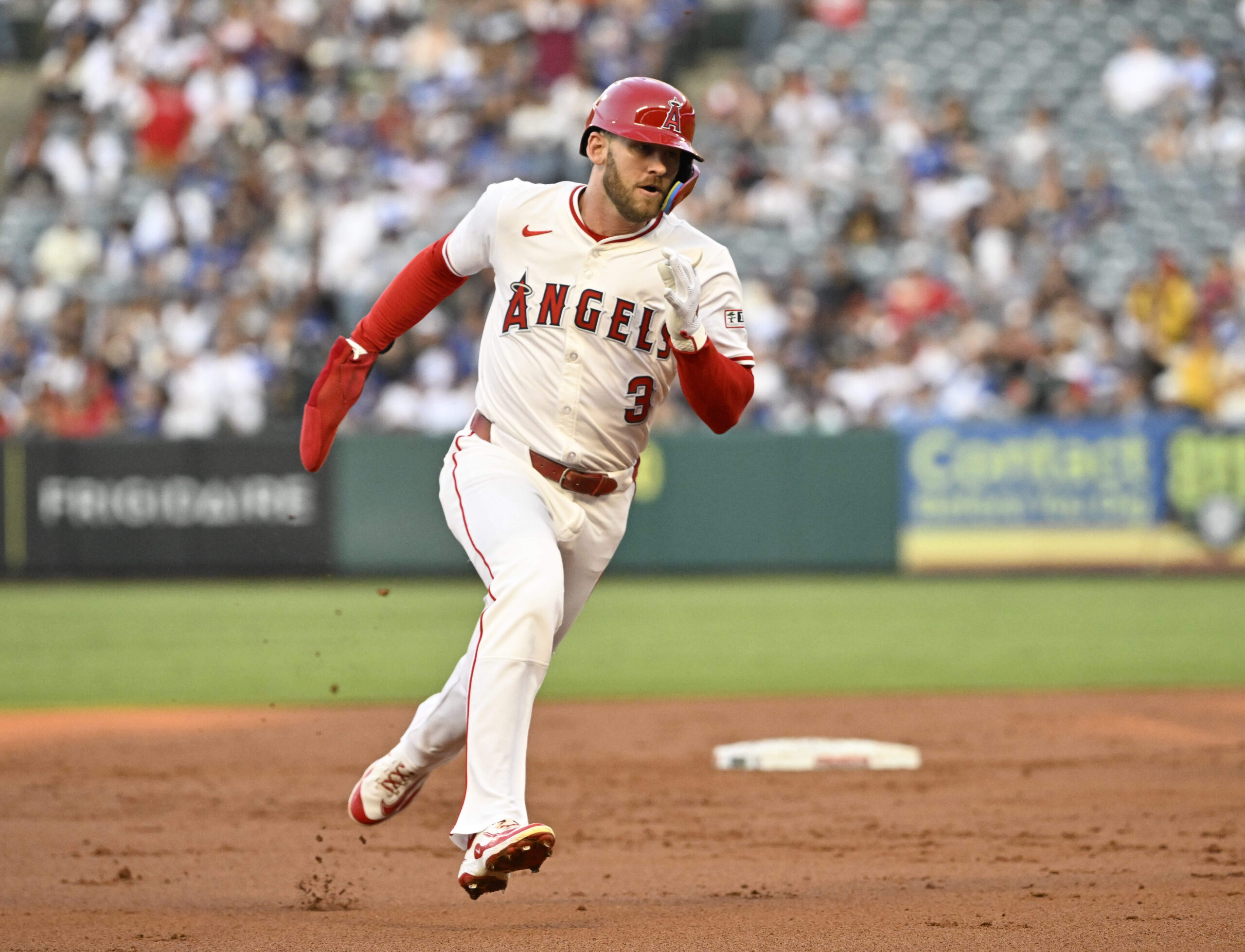 The Angels’ Taylor Ward runs to third base on an...