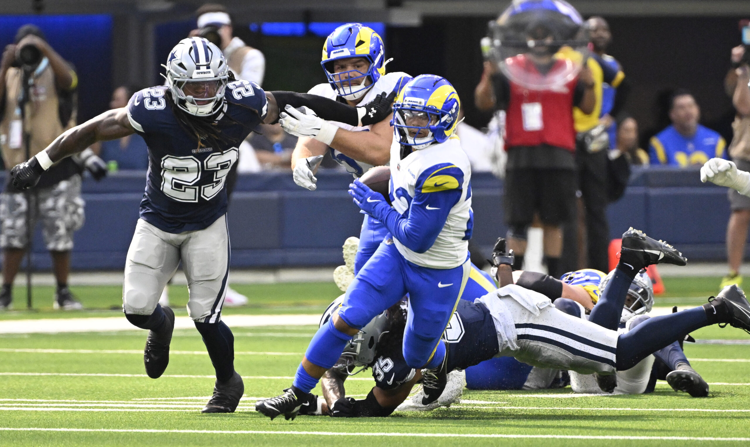 Running back Blake Corum #22 of the Rams runs for...