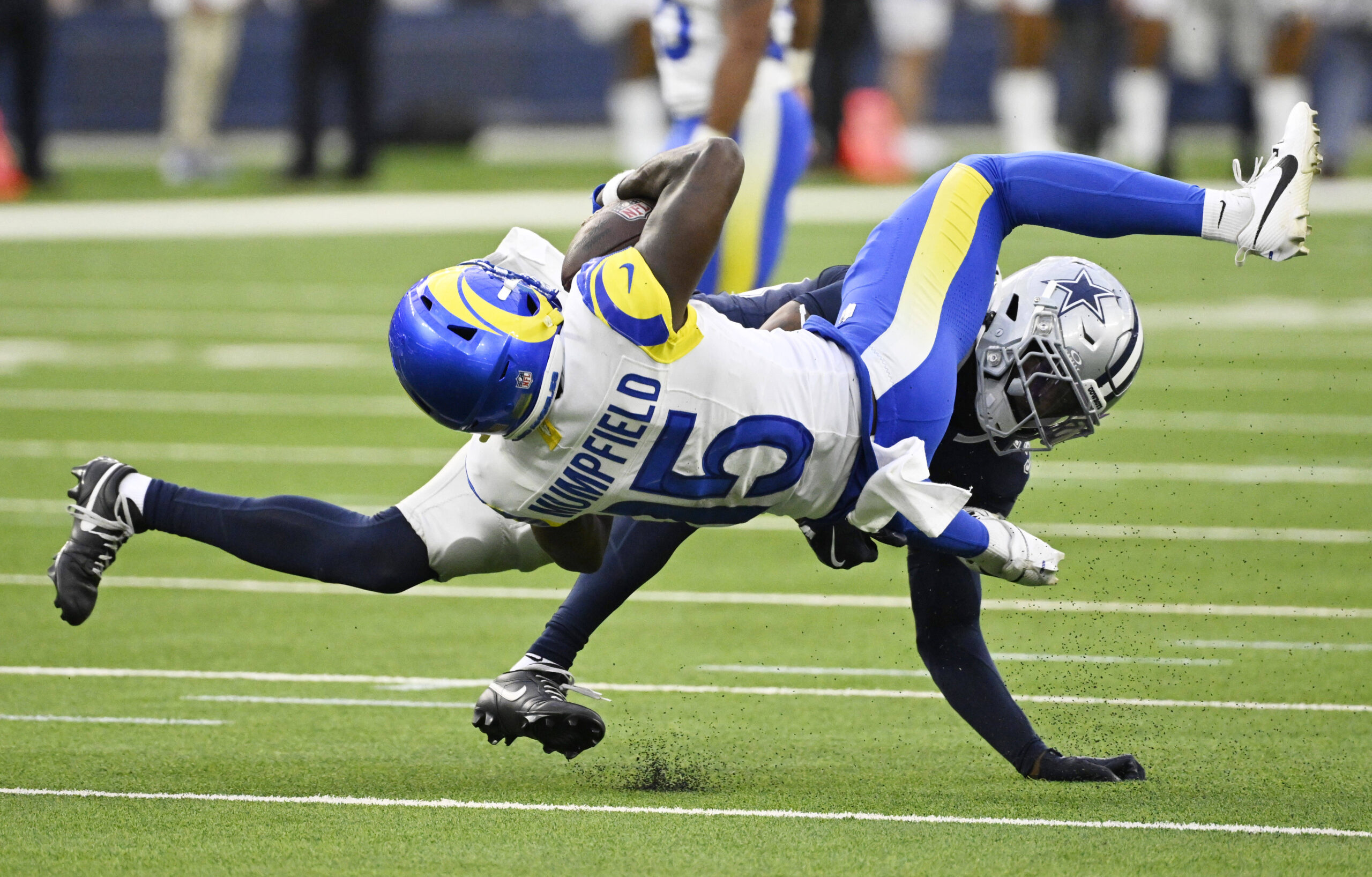 Wide receiver Konata Mumpfield #15 of Rams juggles and catches...