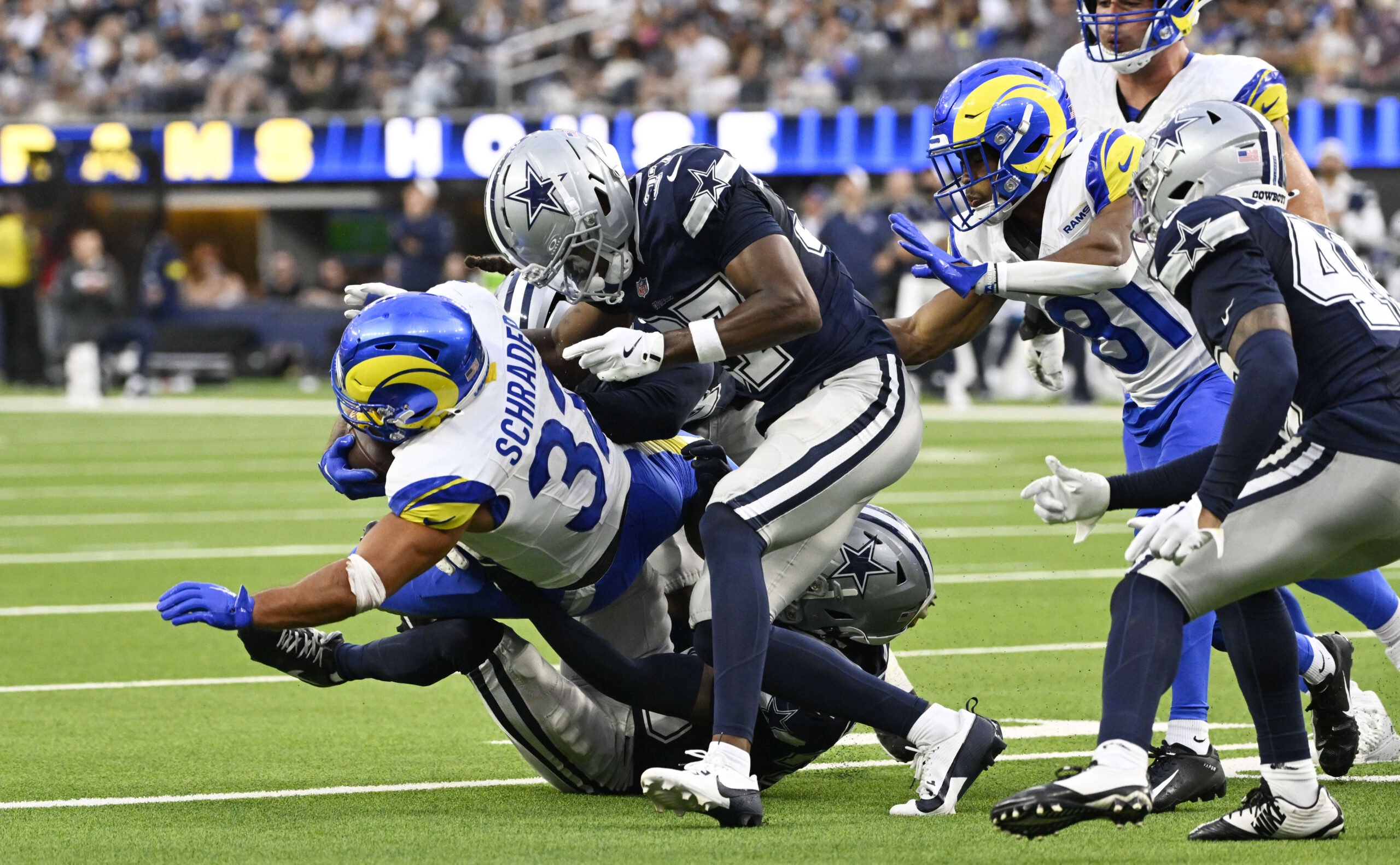 Running back Cody Schrader #32 of the Rams runs for...