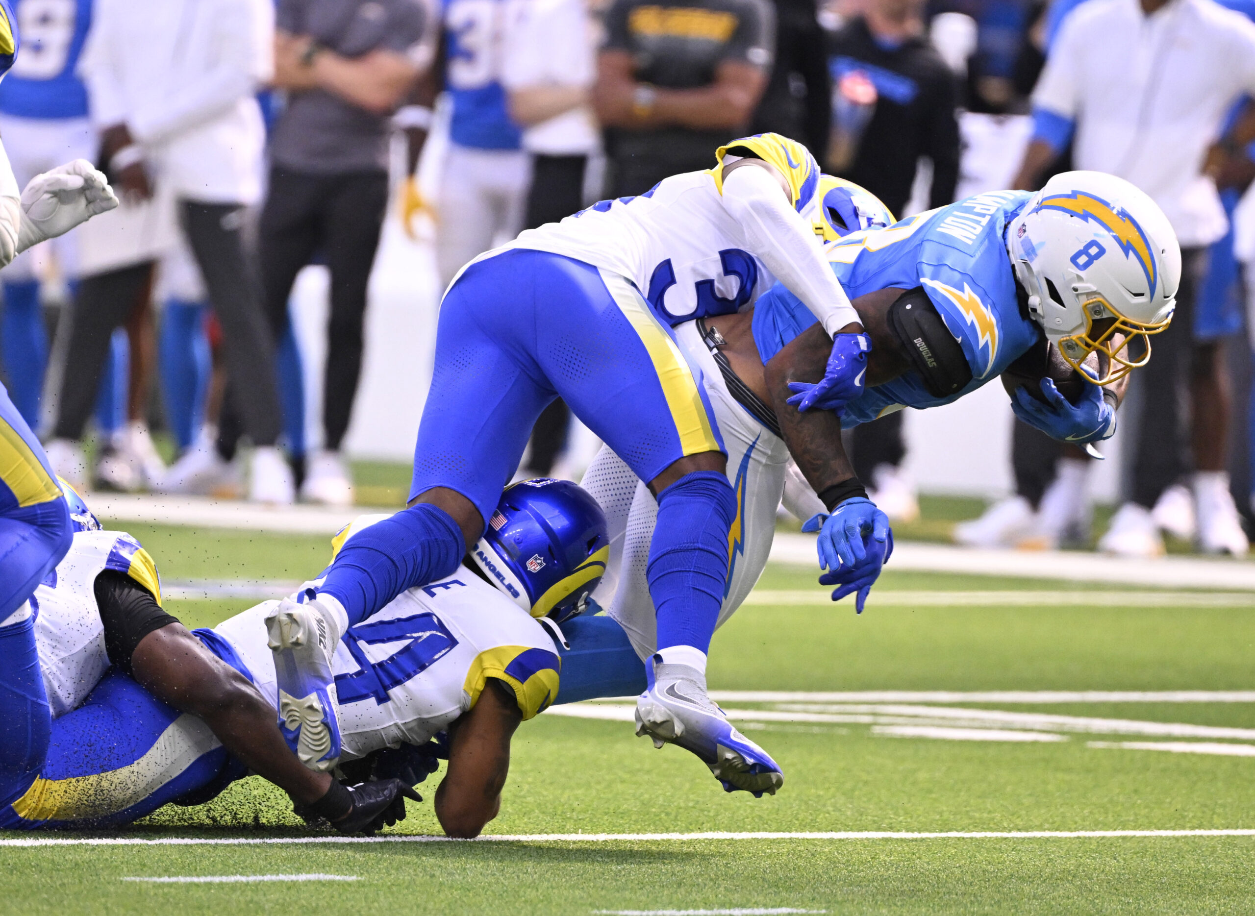 Running back Omarion Hampton #8 of the Chargers runs for...