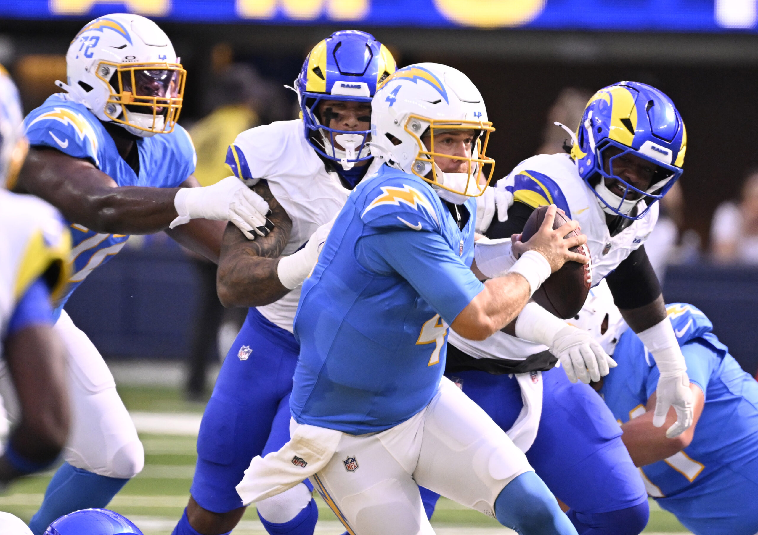 Quarterback Taylor Heinicke #4 of the Chargers scrambles for a...