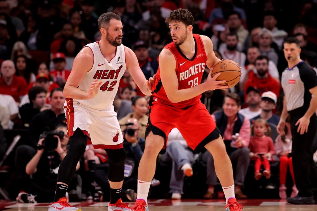 Dec 29, 2024; Houston, Texas, USA; Houston Rockets center Alperen Sengun (28) handles the ball against Miami Heat forward Kevin Love (42) during the third quarter at Toyota Center. Mandatory Credit: Erik Williams-Imagn Images