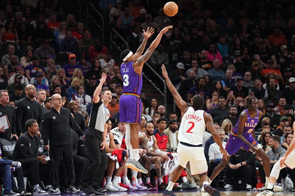Mar 4, 2025; Phoenix, Arizona, USA; Phoenix Suns guard Bradley Beal (3) shoots against LA Clippers forward Kawhi Leonard (2) during the first half at PHX Center. Mandatory Credit: Joe Camporeale-Imagn Images