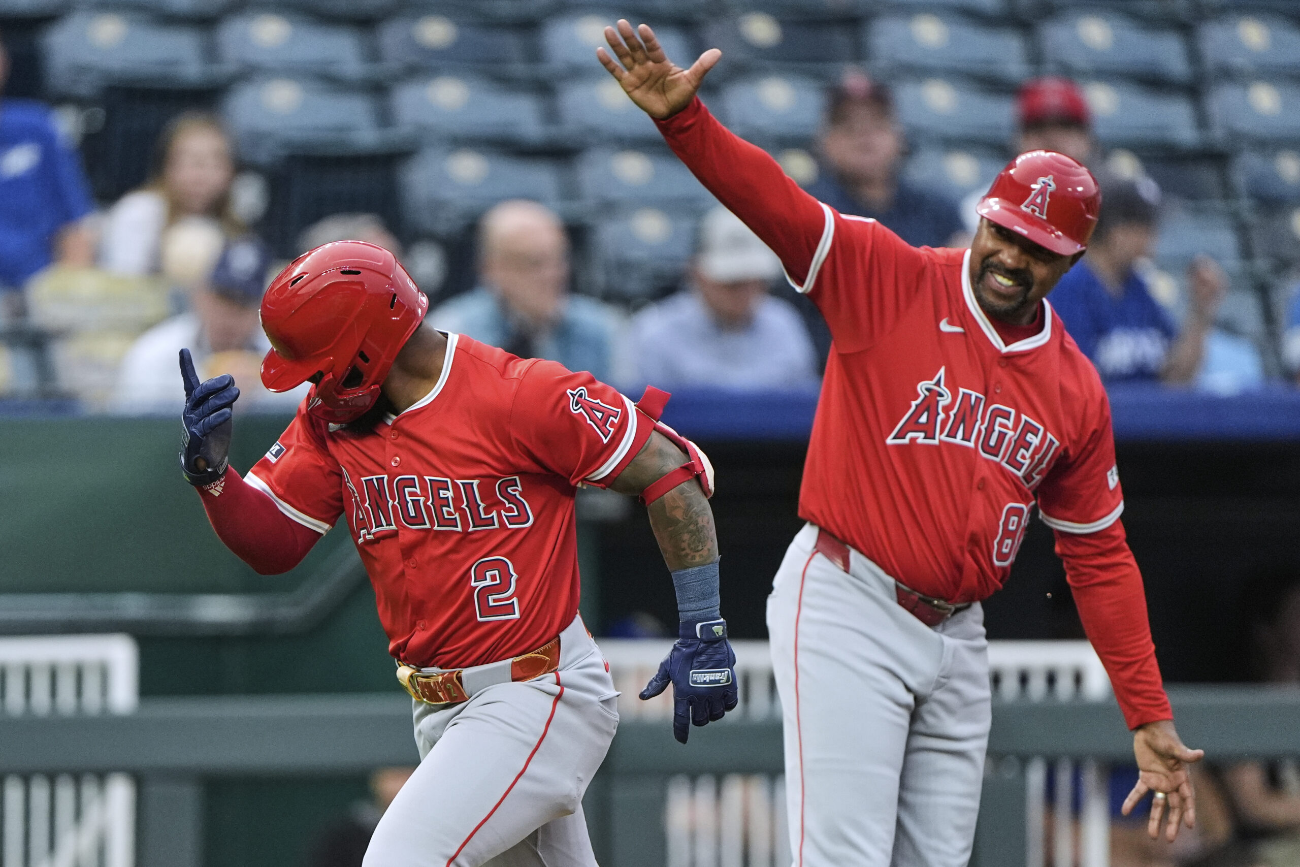 The Angels’ Luis Rengifo (2) celebrates with third base coach...