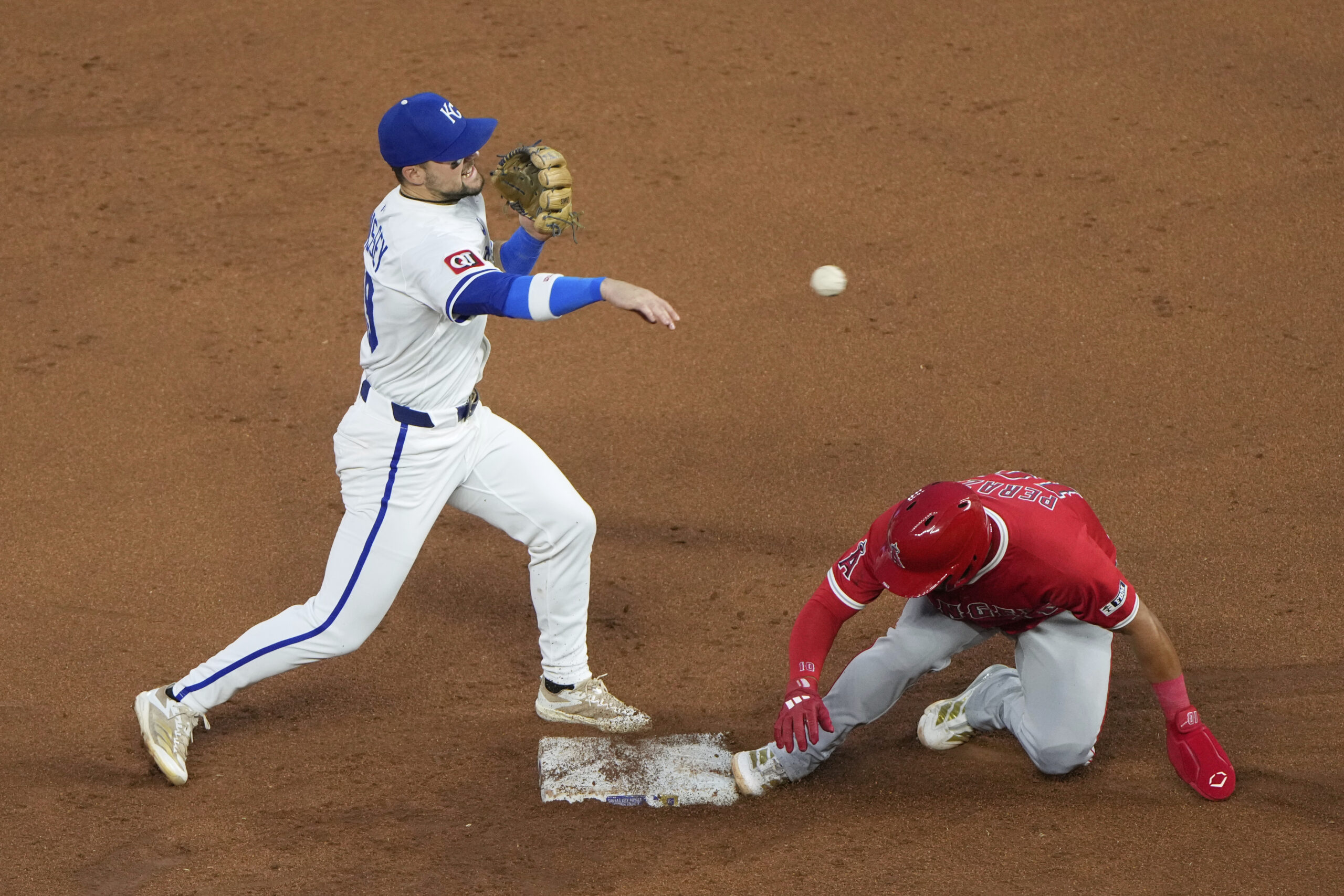 Kansas City Royals second baseman Michael Massey, left, throws to...