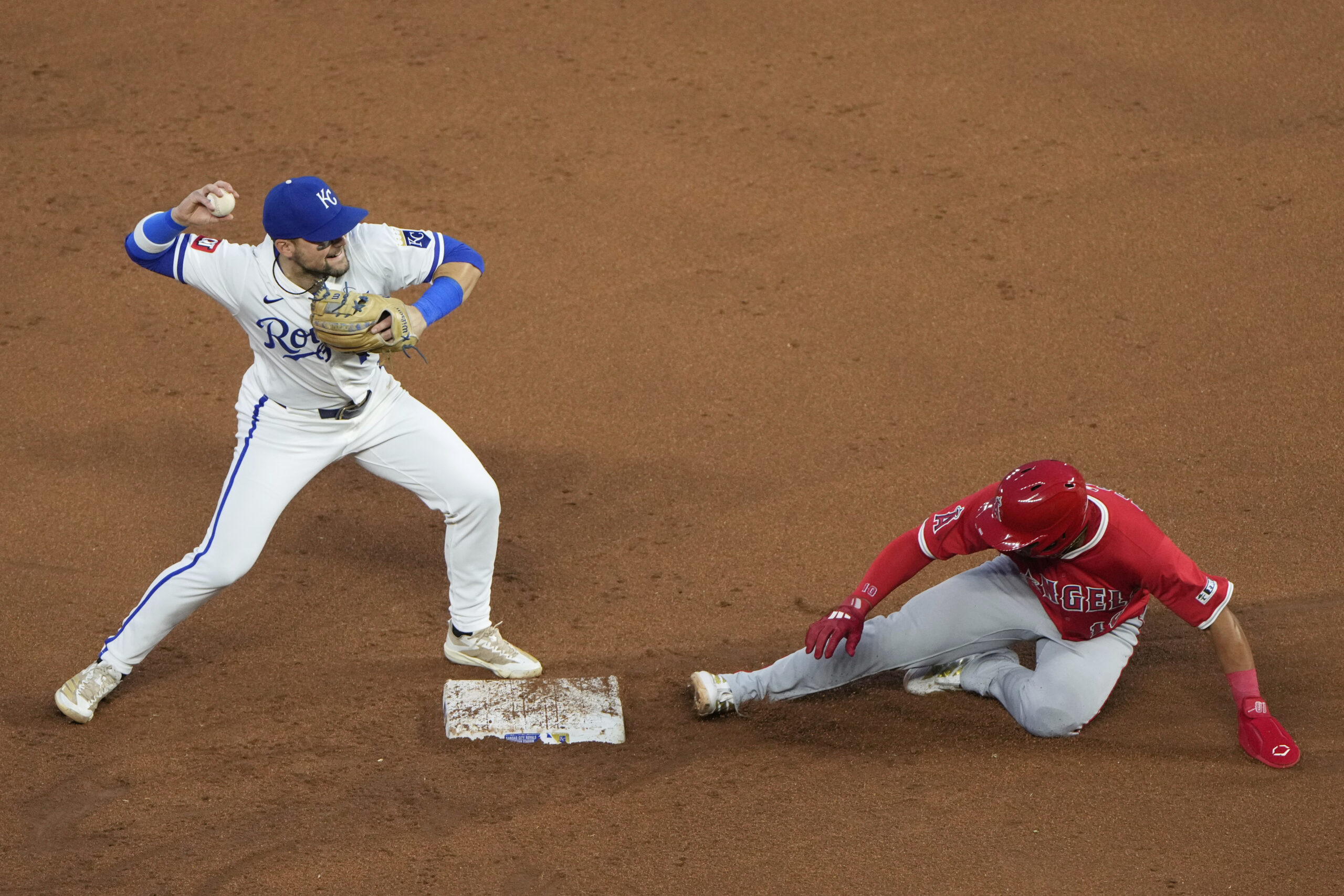 Kansas City Royals second baseman Michael Massey, left, throws to...