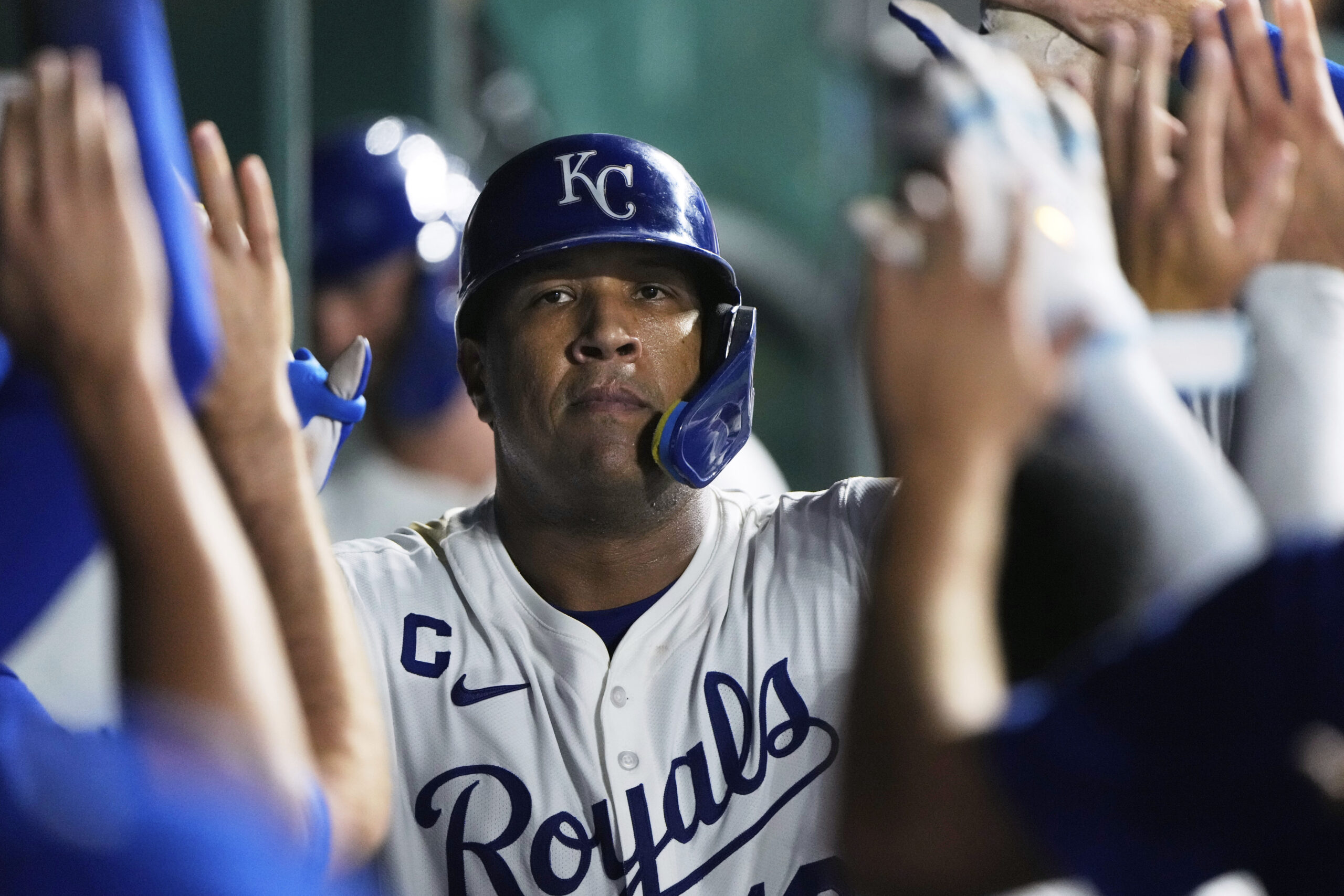 Kansas City Royals’ Salvador Perez celebrates in the dugout after...