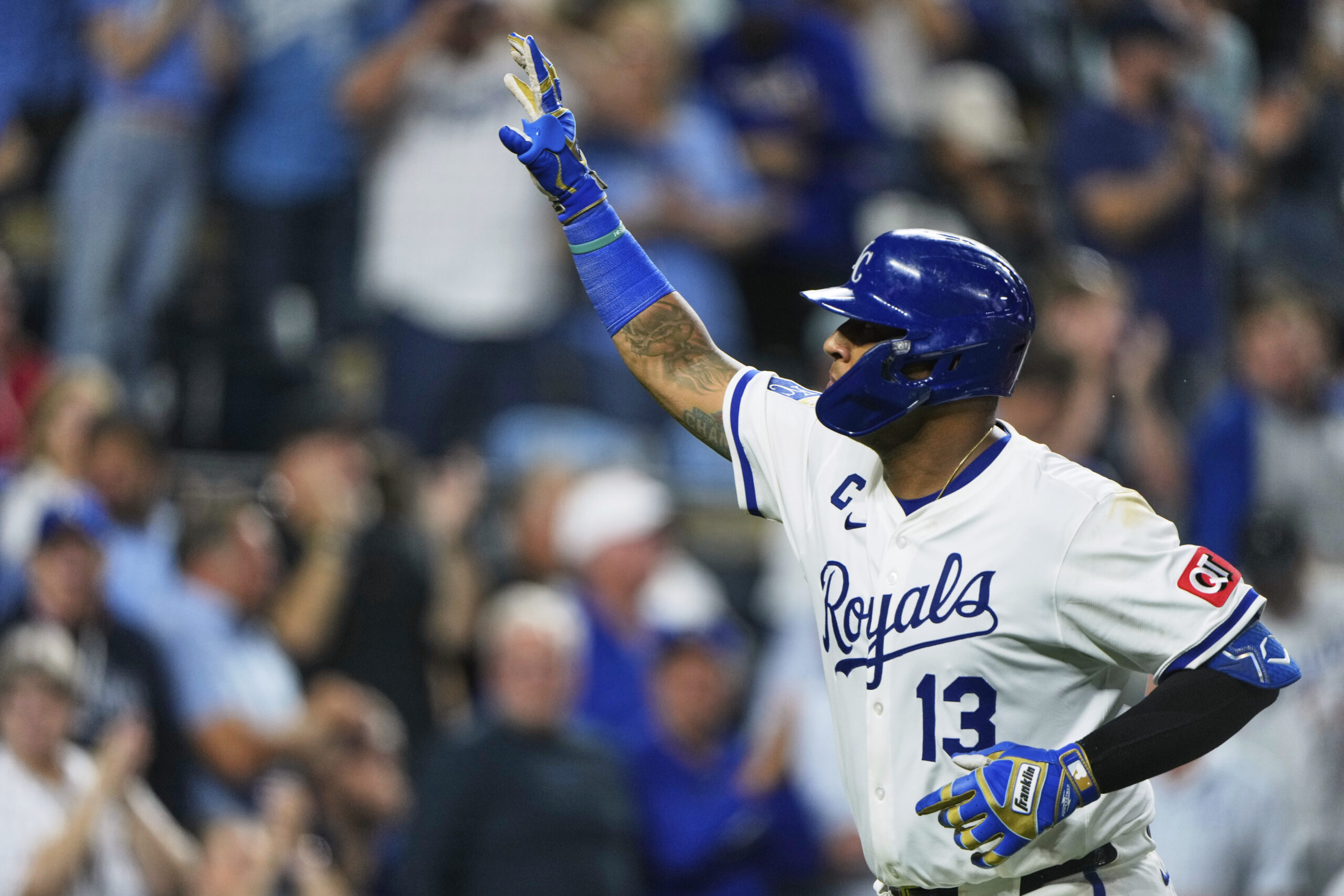 Kansas City Royals’ Salvador Perez celebrates as he crosses the...