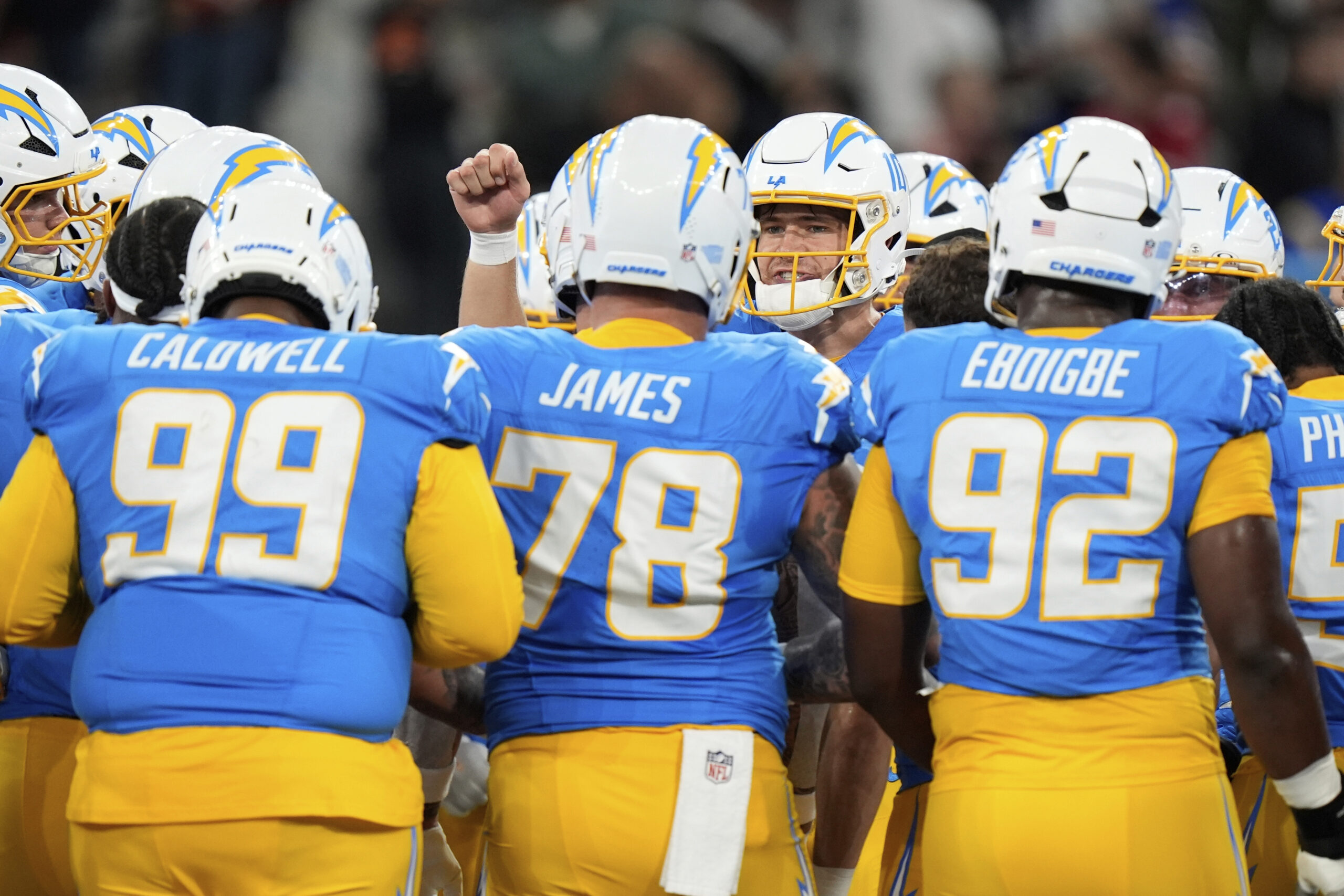 Chargers quarterback Justin Herbert talks to the team before an...