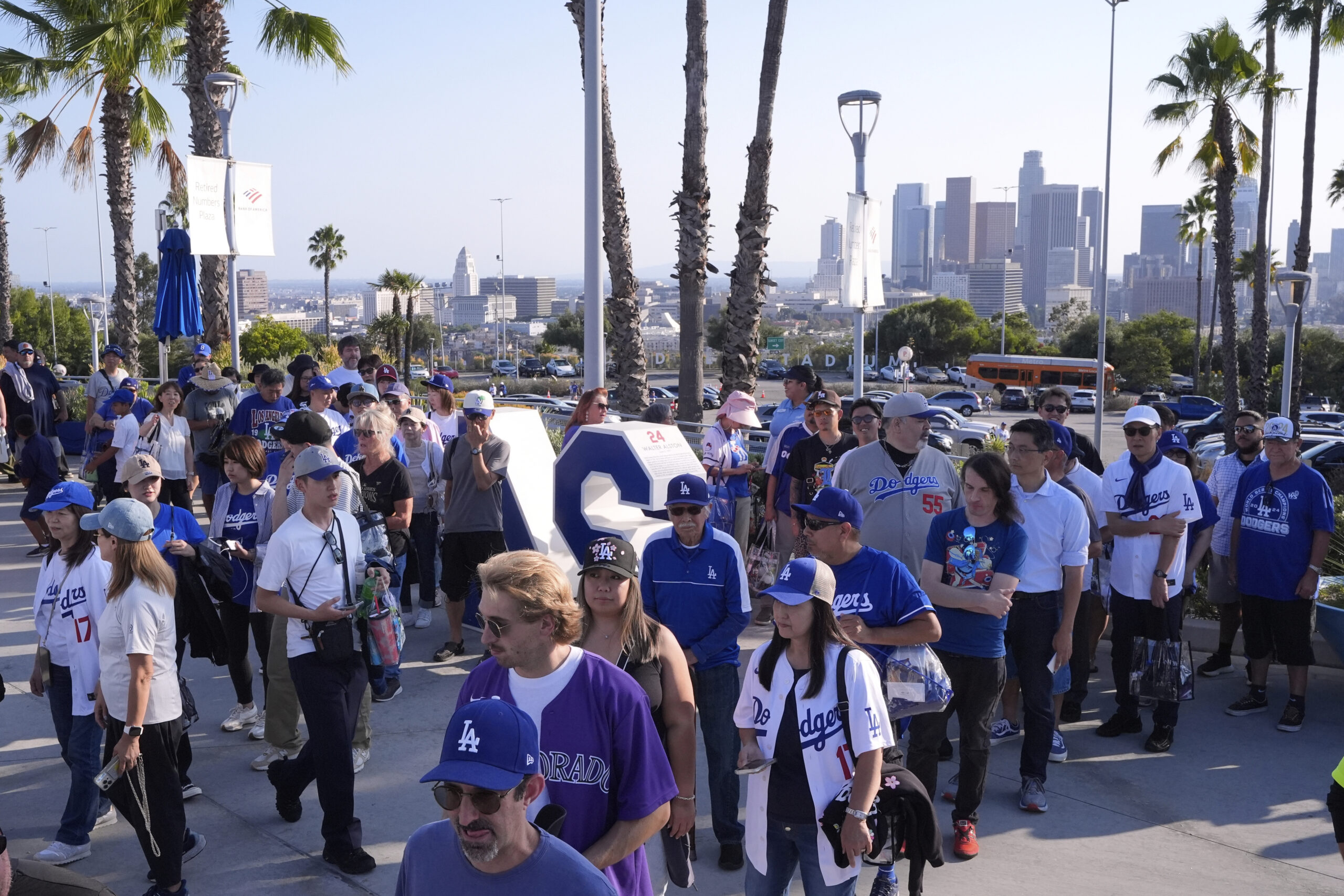 Fans line up at the entrance to Dodger Stadium to...