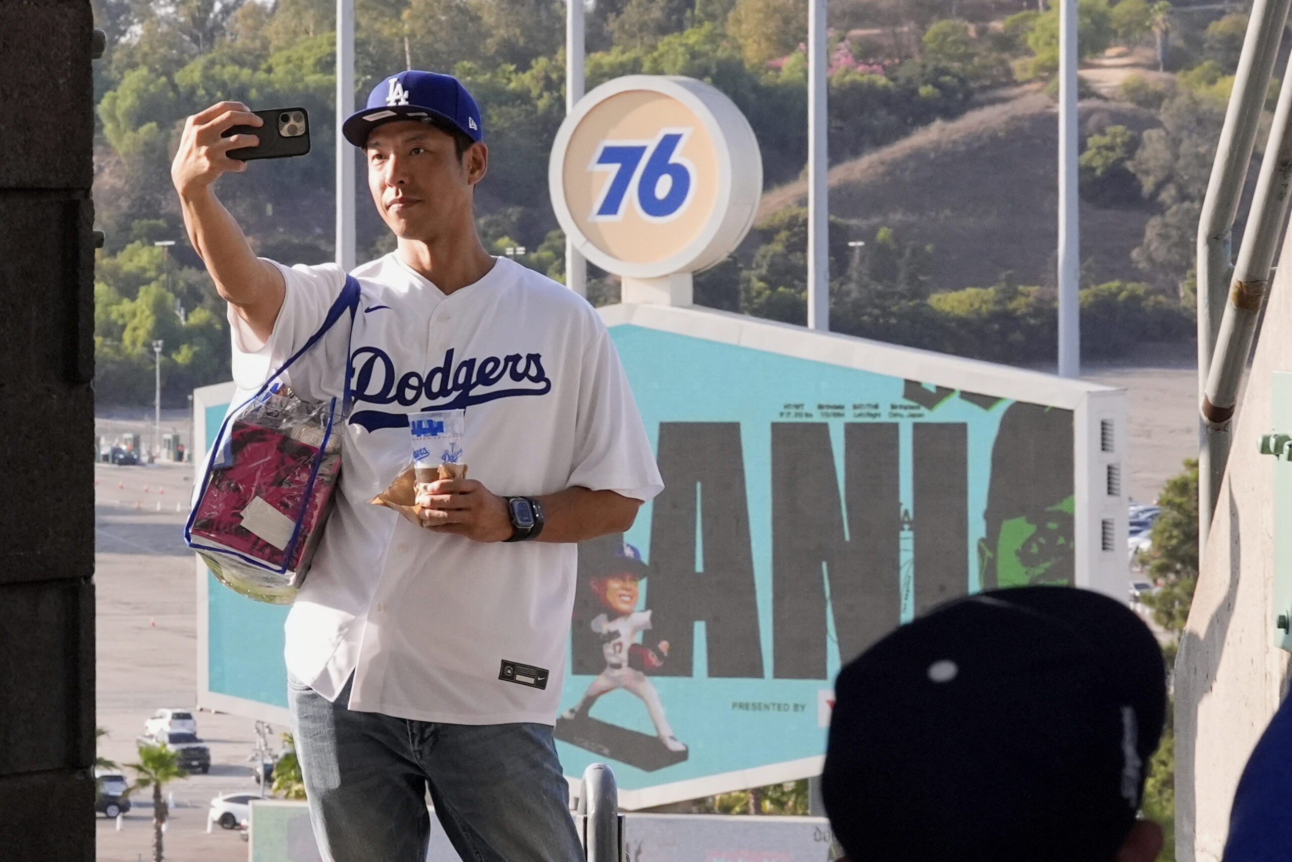 A fan takes a selfie of himself at Dodger Stadium...