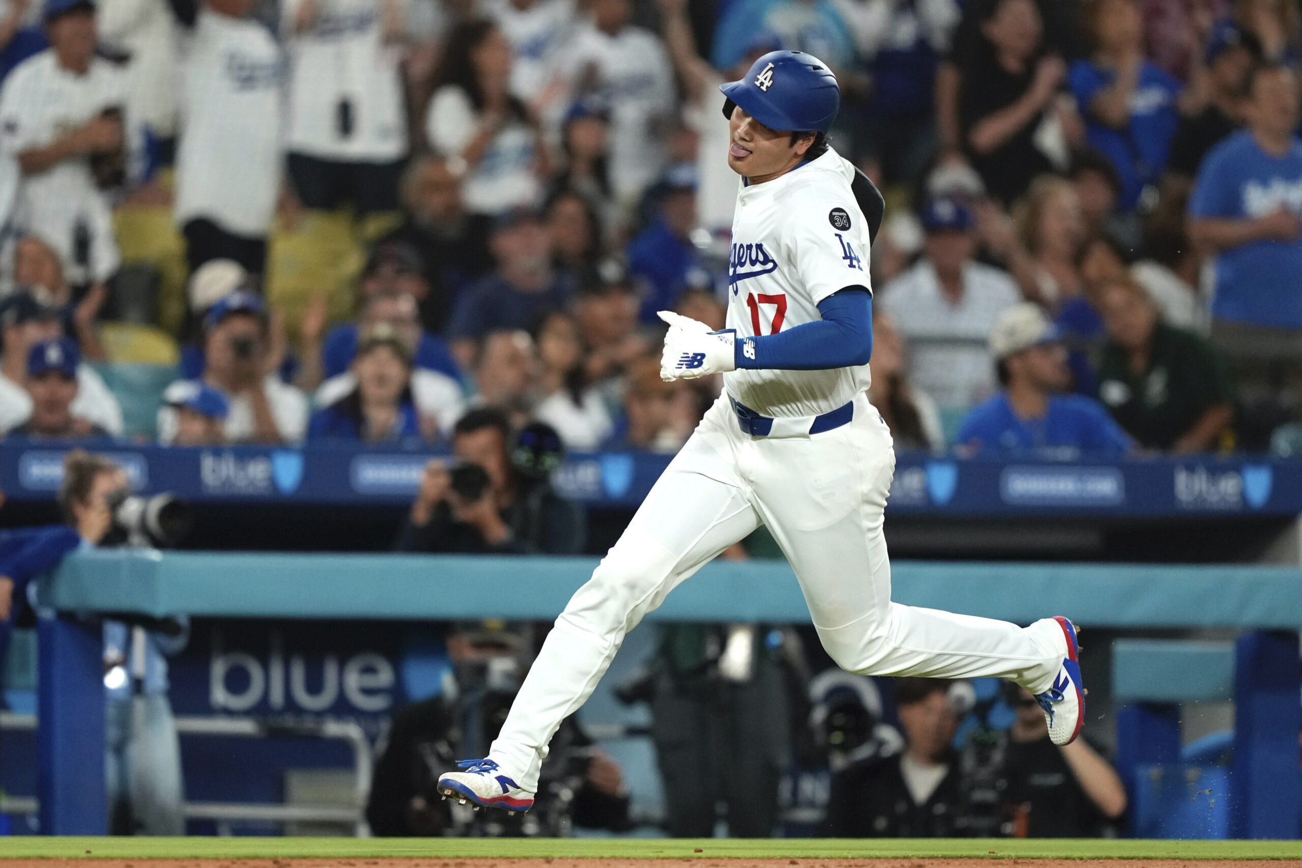 Dodgers star Shohei Ohtani heads home to score on a...