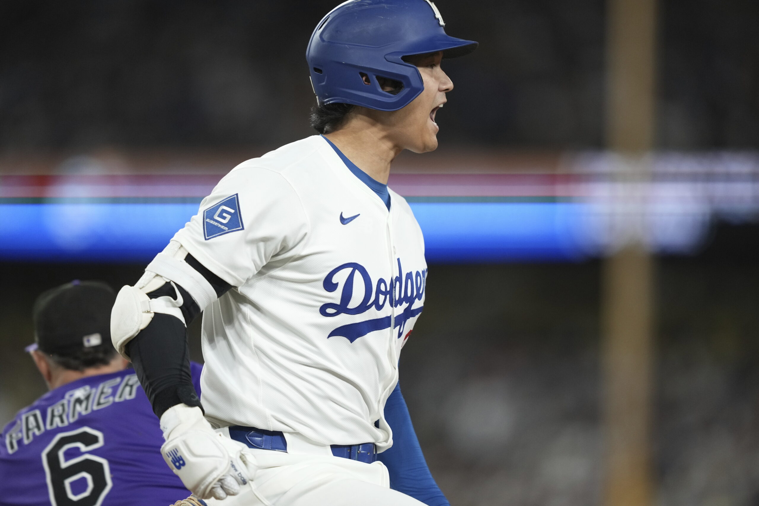 Dodgers star Shohei Ohtani yells as he is forced out...