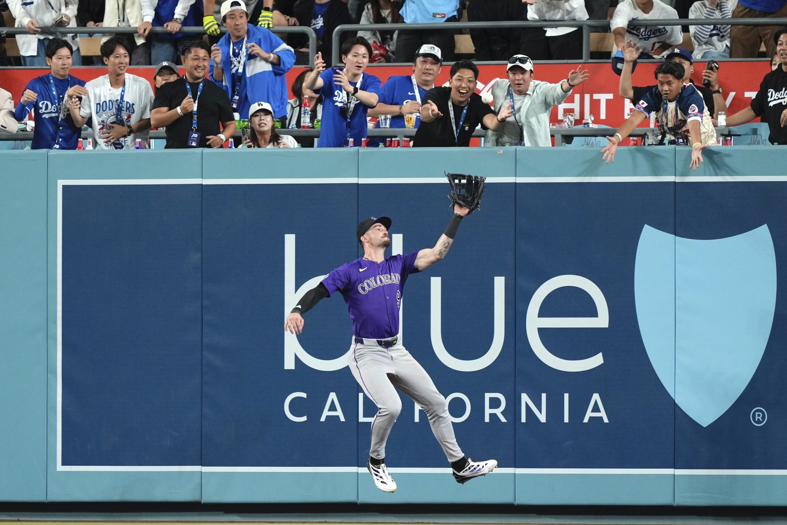 Colorado Rockies center fielder Brenton Doyle makes a catch on...