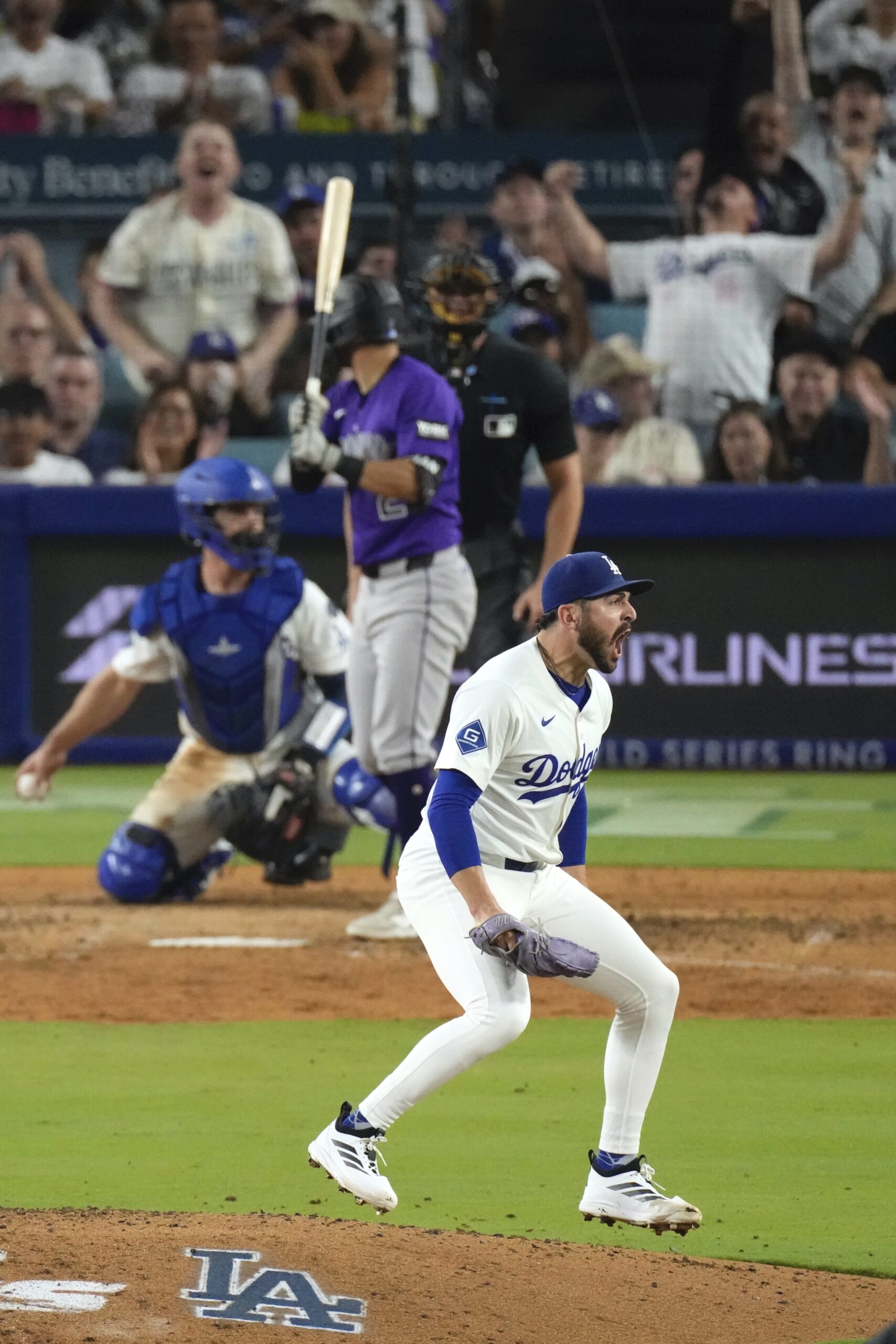 Dodgers relief pitcher Alex Vesia, right, celebrates after striking out...