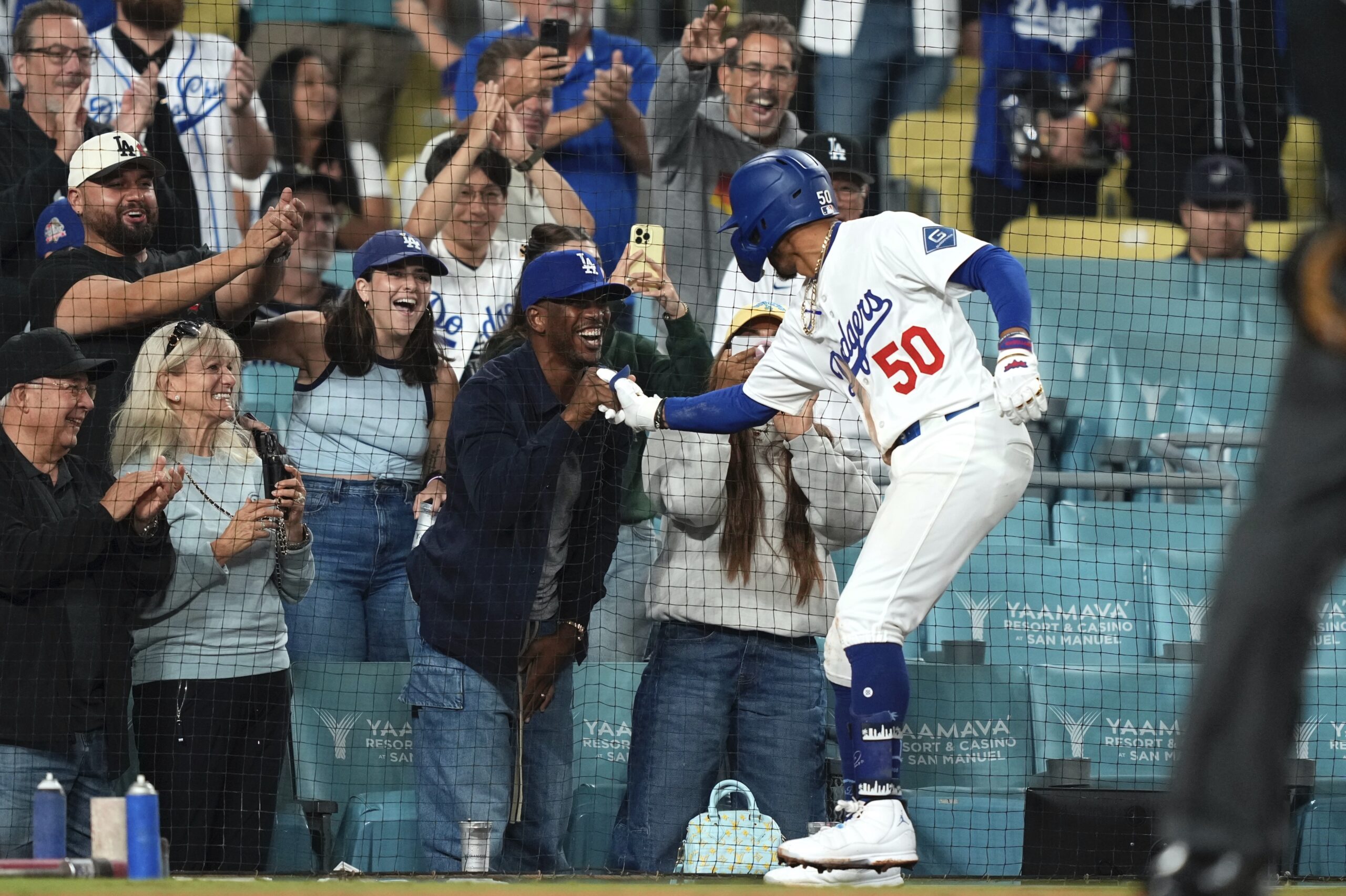 The Dodgers’ Mookie Betts, right, greets Clippers guard Chris Paul...