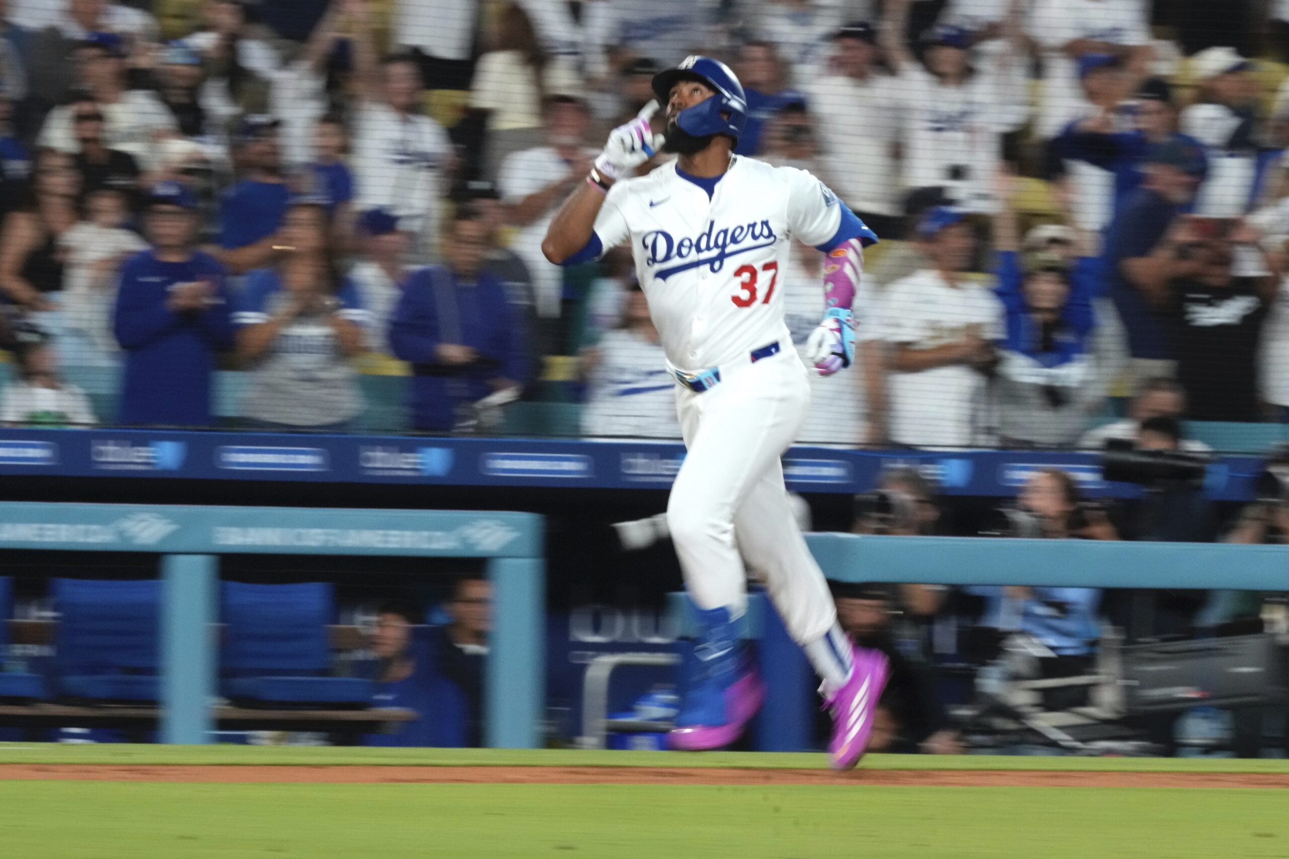 The Dodgers’ Teoscar Hernández gestures as he runs the bases...