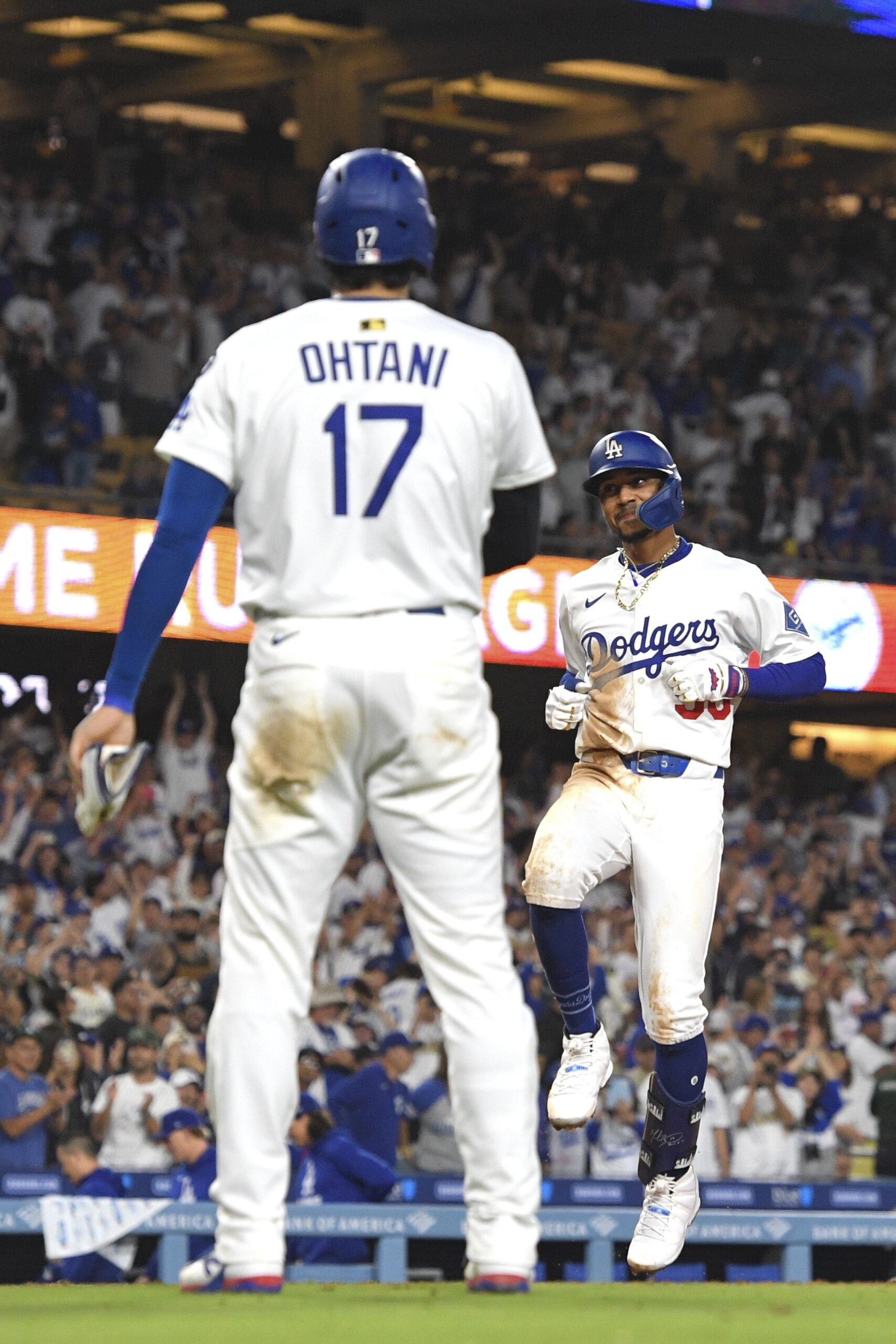 The Dodgers’ Mookie Betts, right, is congratulated by teammate Shohei...