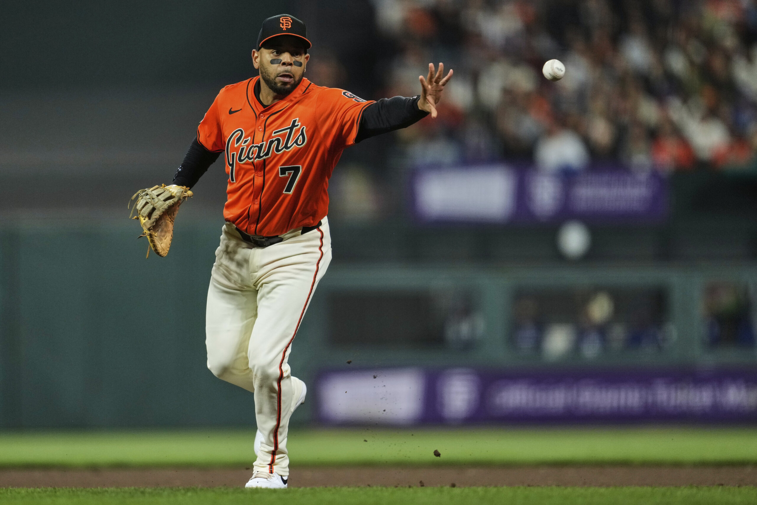 San Francisco Giants first baseman Dominic Smith tosses the ball...