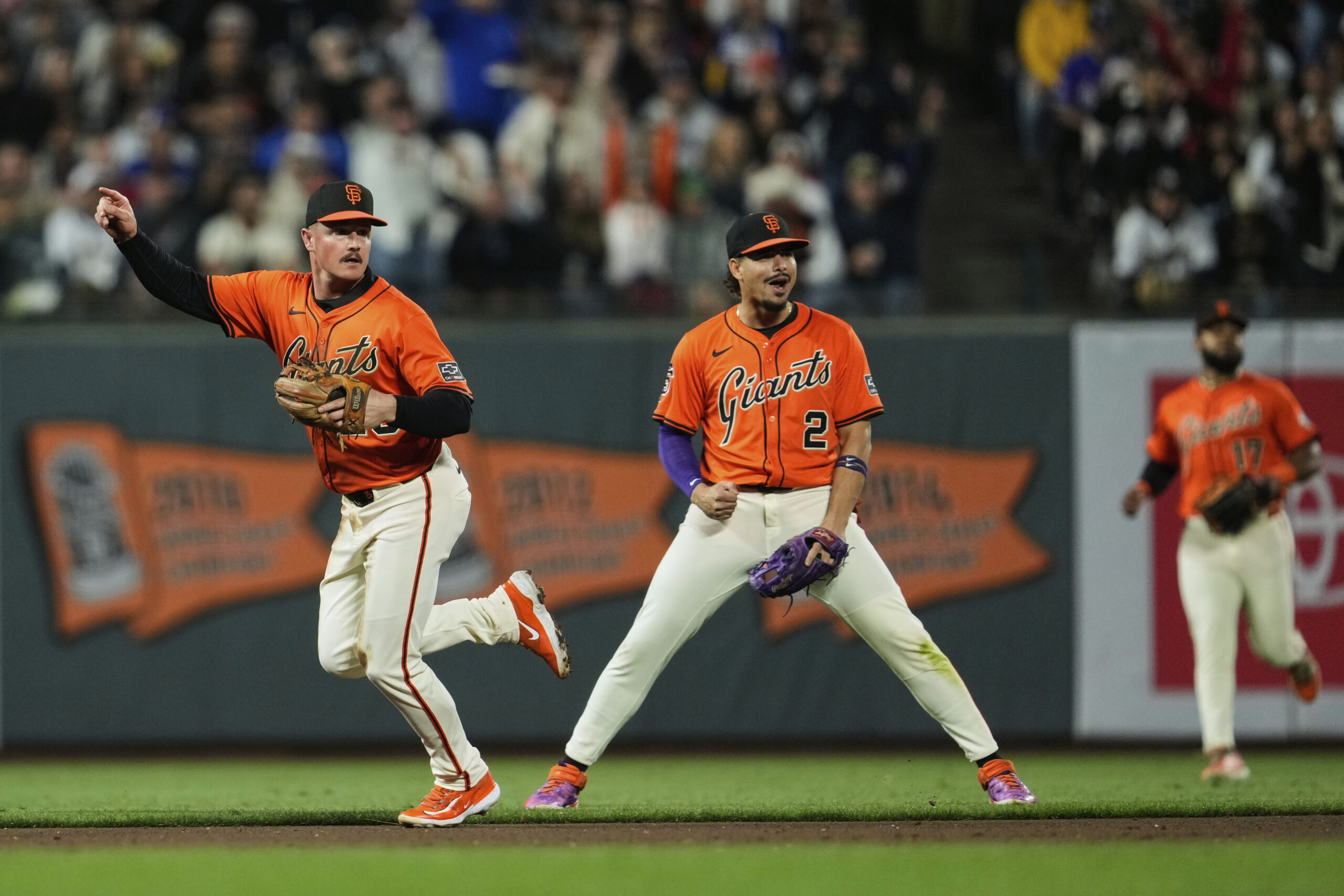 San Francisco Giants third baseman Matt Chapman, left, watches his...