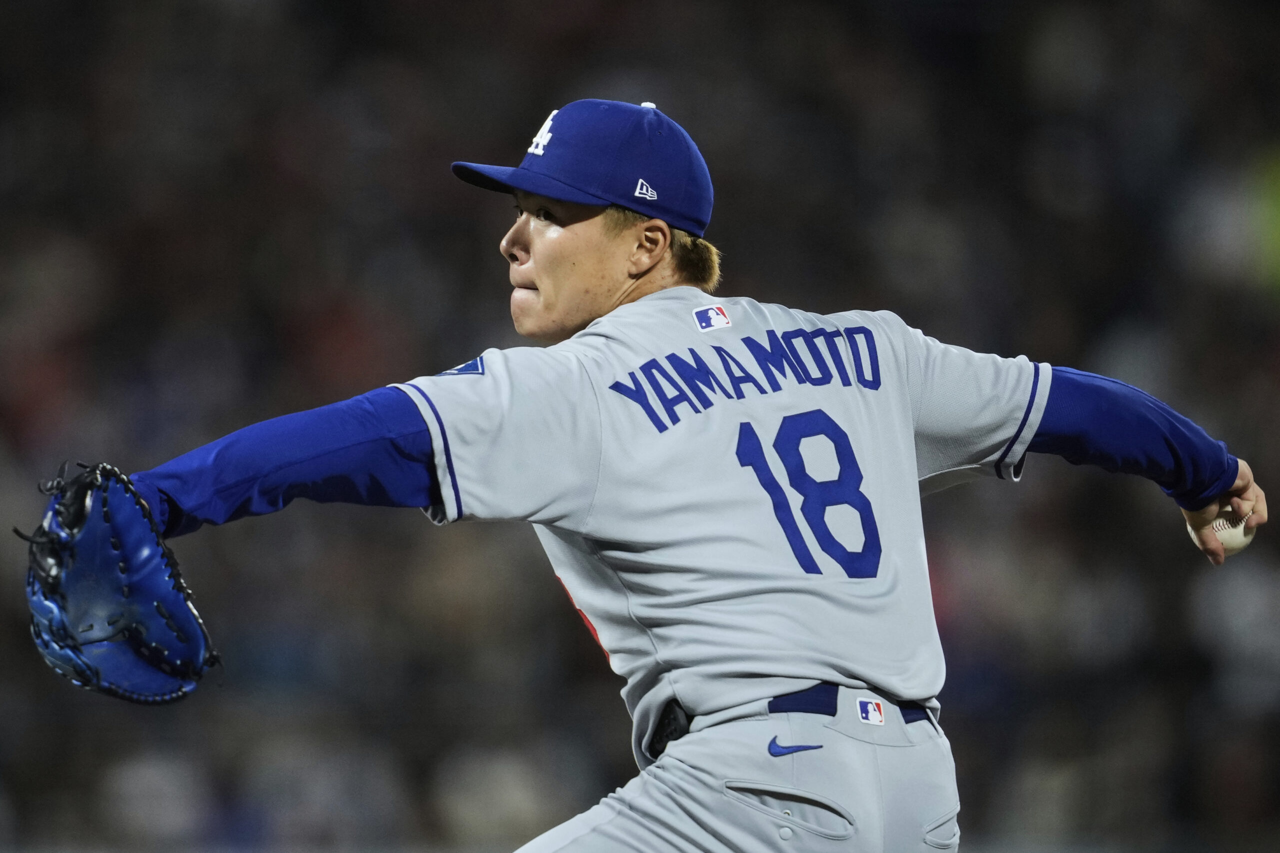 Dodgers starting pitcher Yoshinobu Yamamoto throws to the plate during...