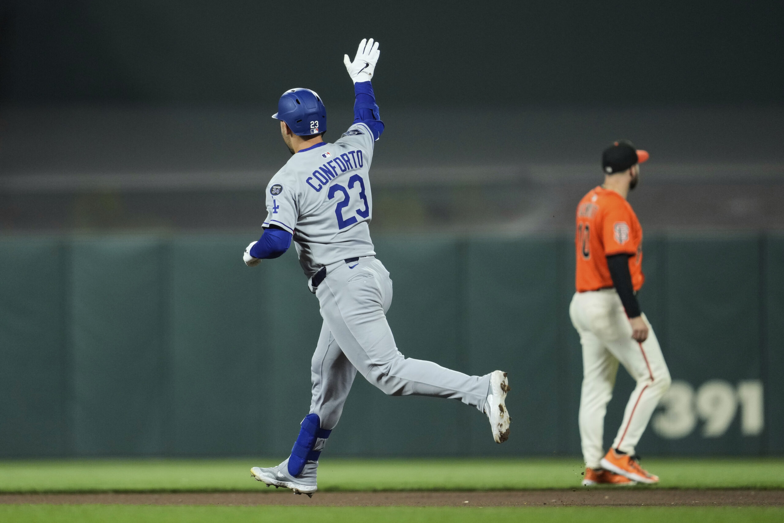 The Dodgers’ Michael Conforto, left, runs the bases after hitting...