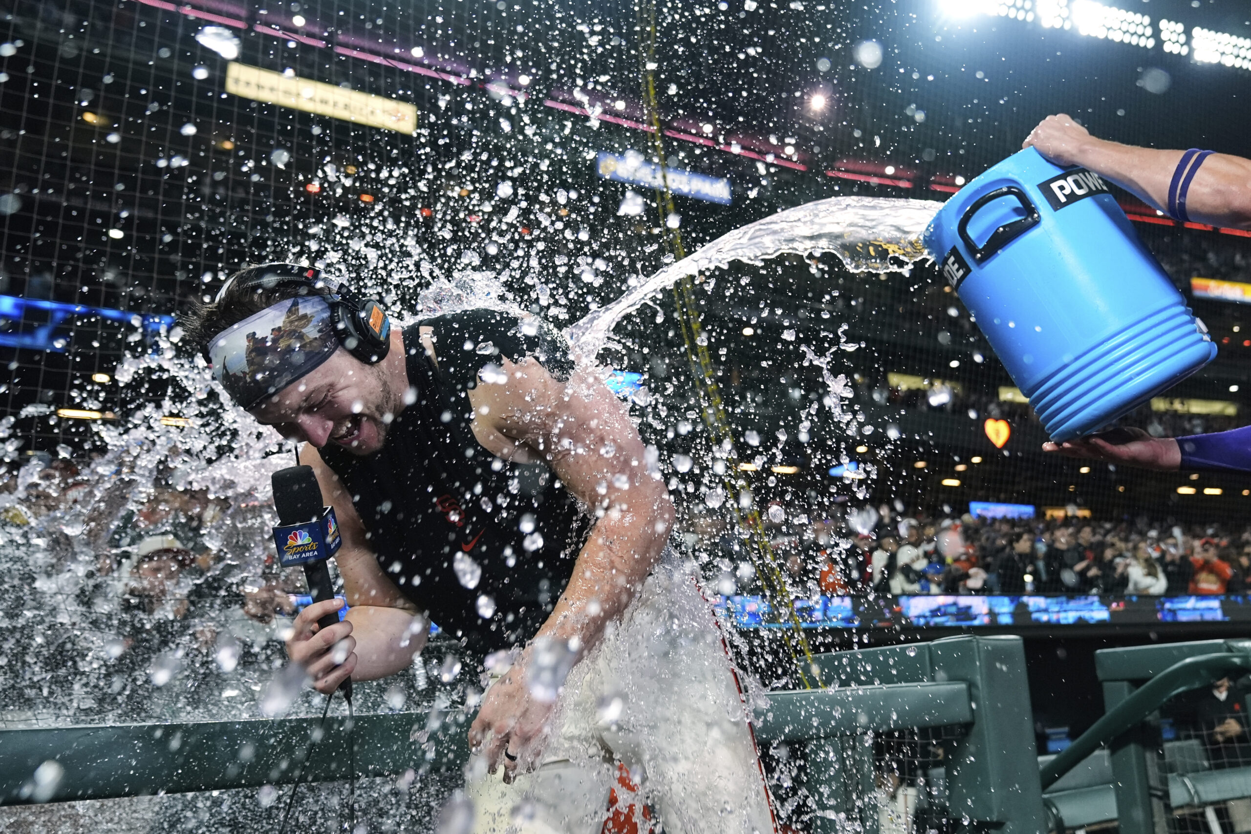 The San Francisco Giants’ Patrick Bailey, left, is doused with...