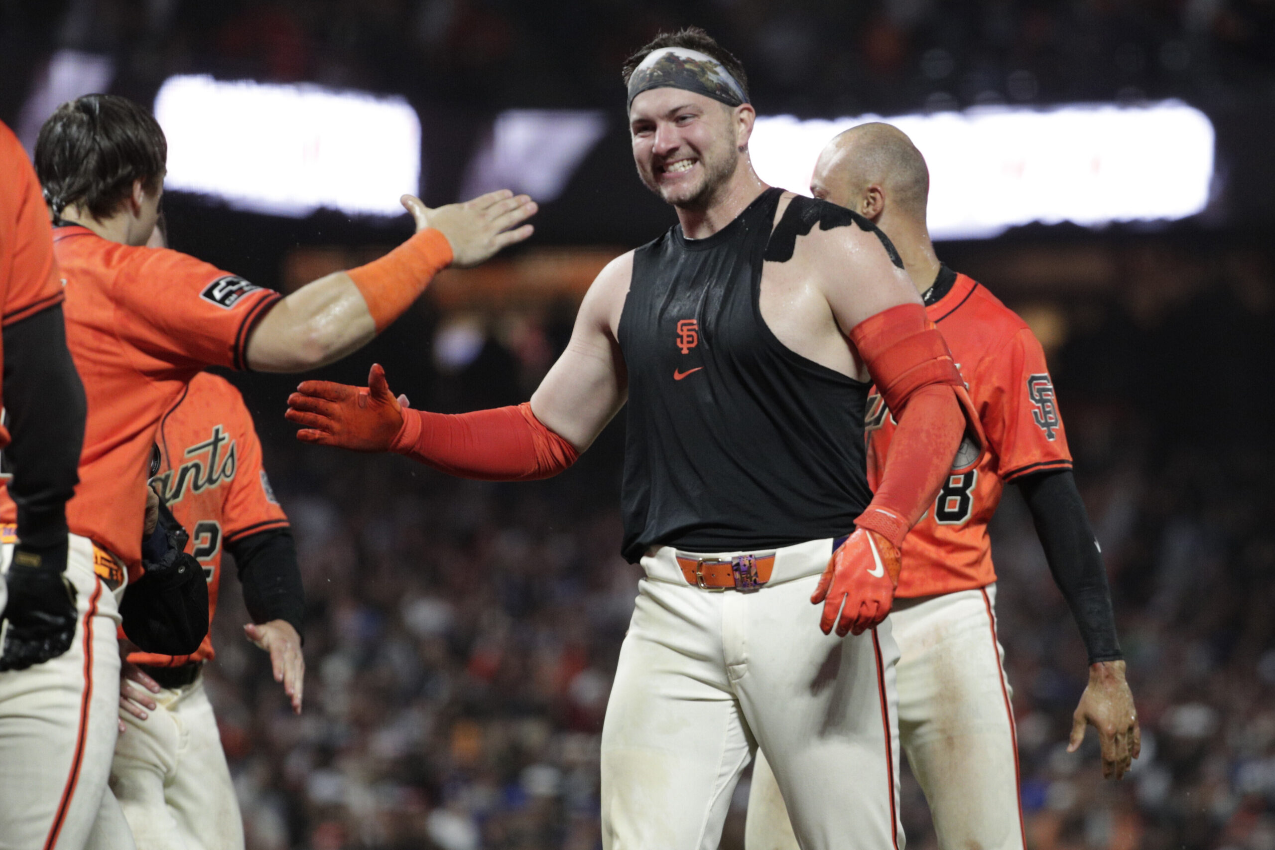 San Francisco Giants catcher Patrick Bailey, center, celebrates with teammates...