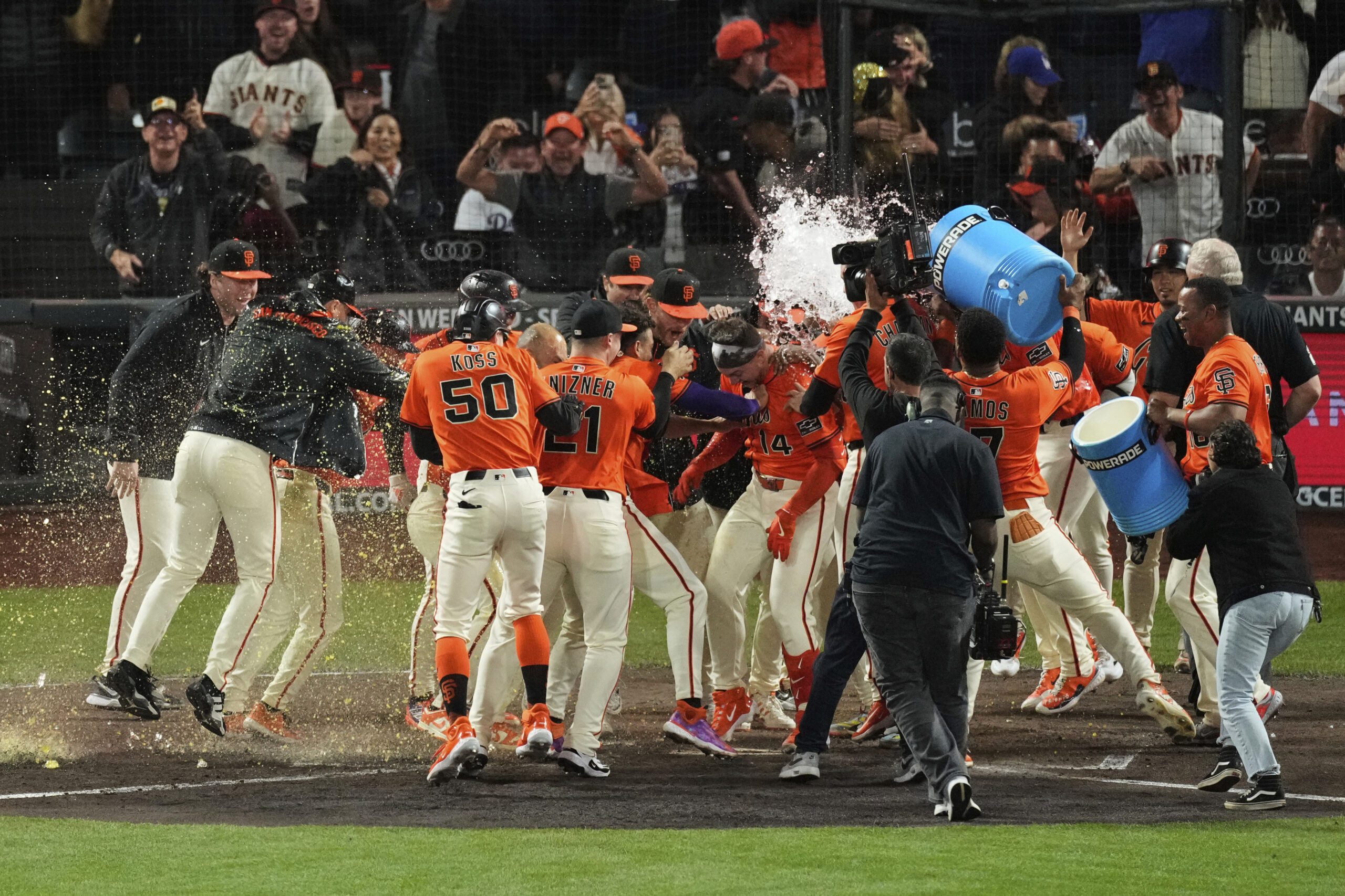 The San Francisco Giants’ Patrick Bailey is mobbed and doused...