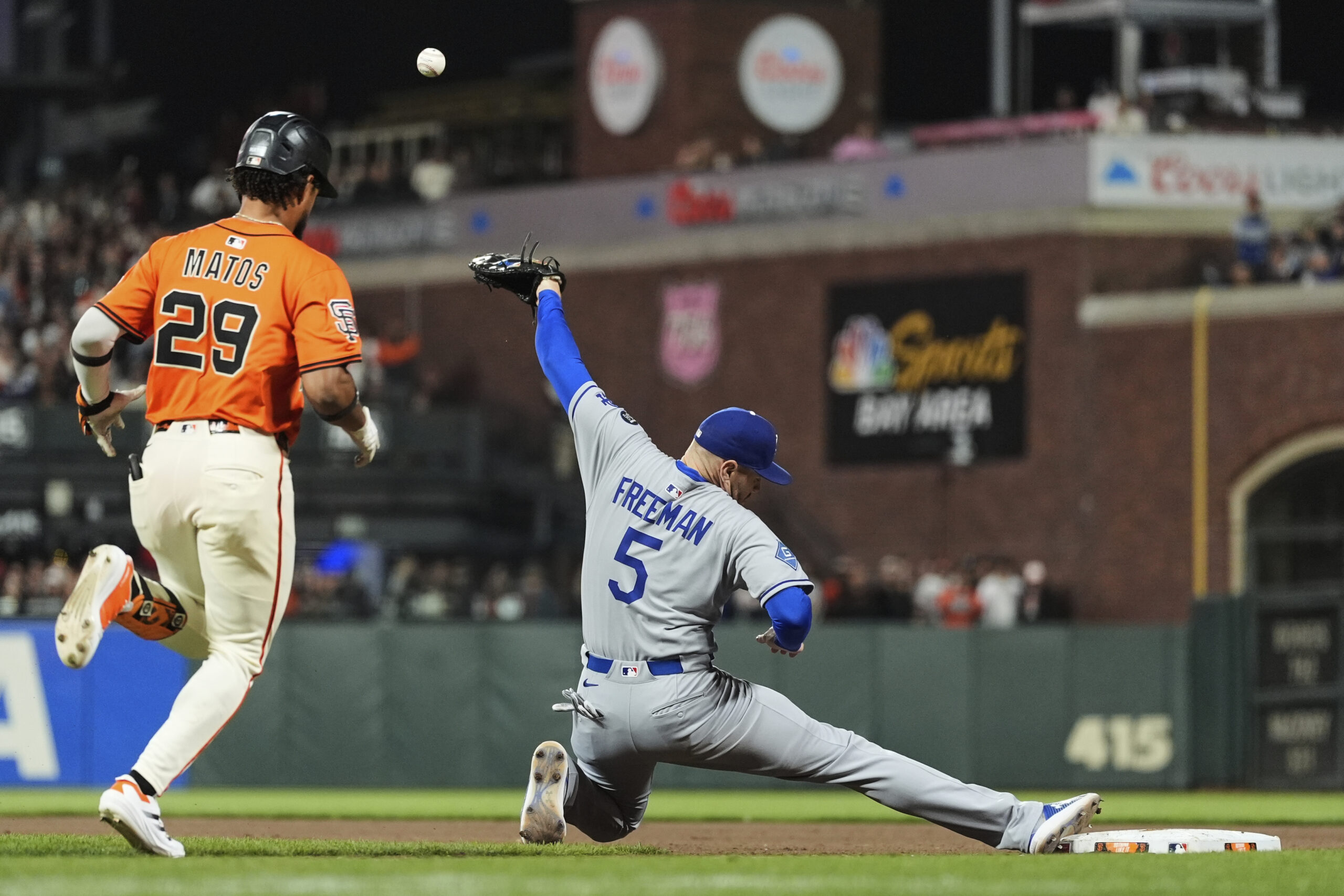 Dodgers first baseman Freddie Freeman, right, is unable to field...