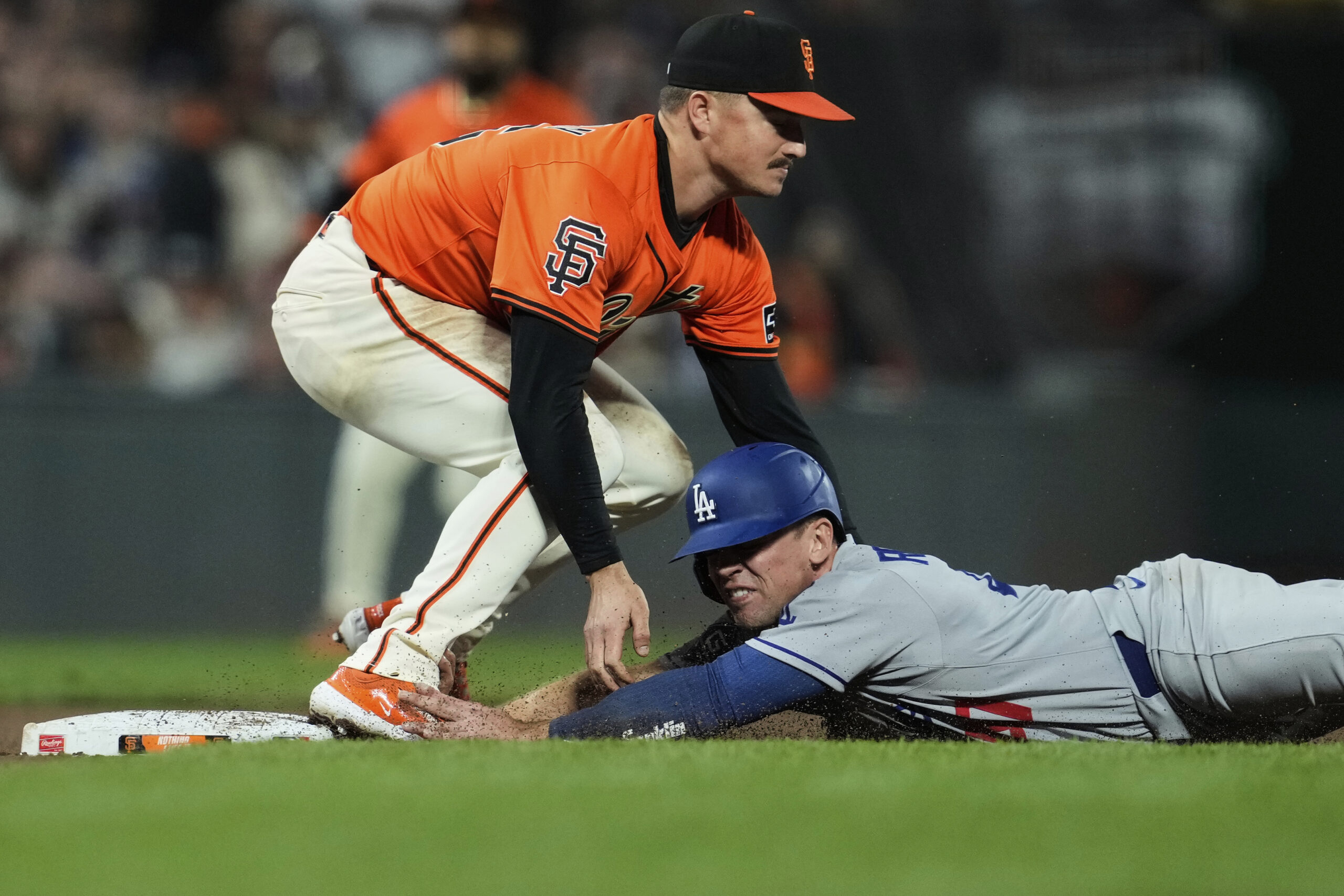 The Dodgers’ Ben Rortvedt, right, is tagged out at third...