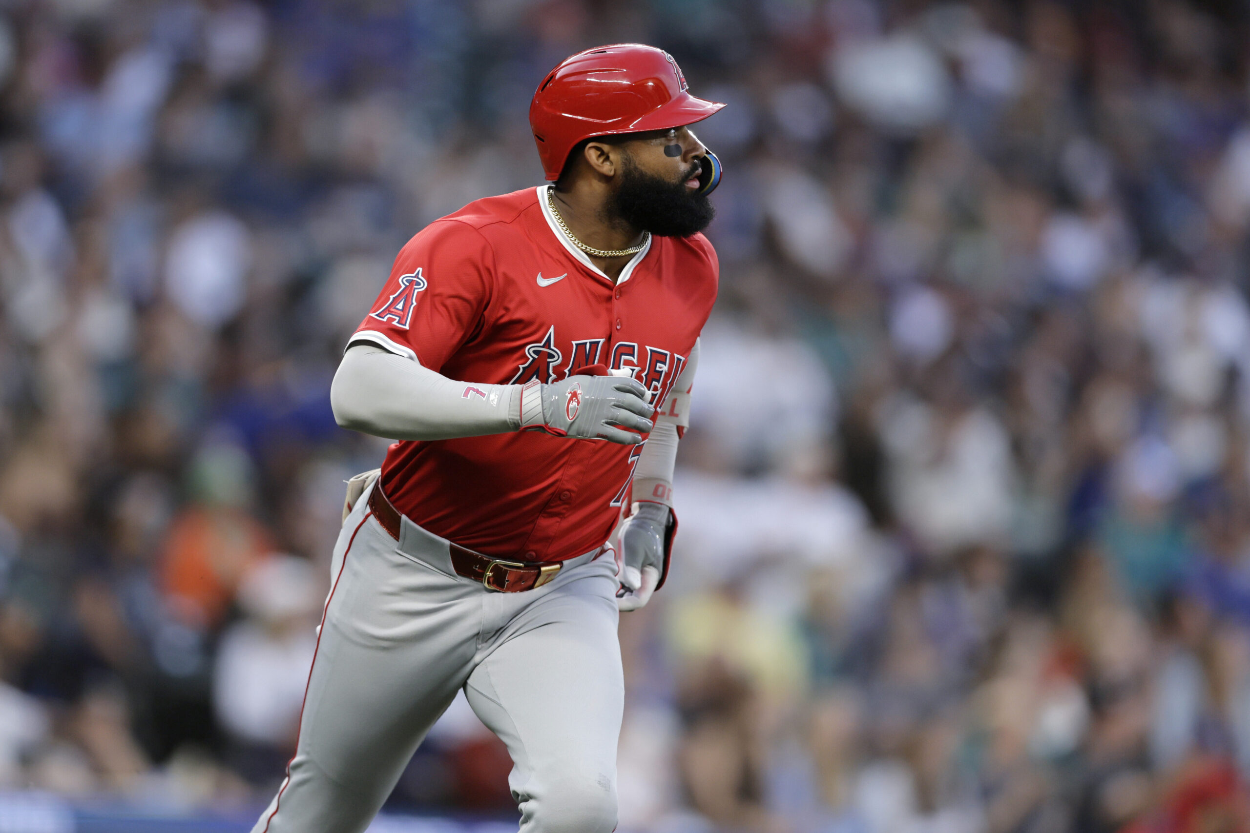 Angels’ Jo Adell watches the flight of his solo home...