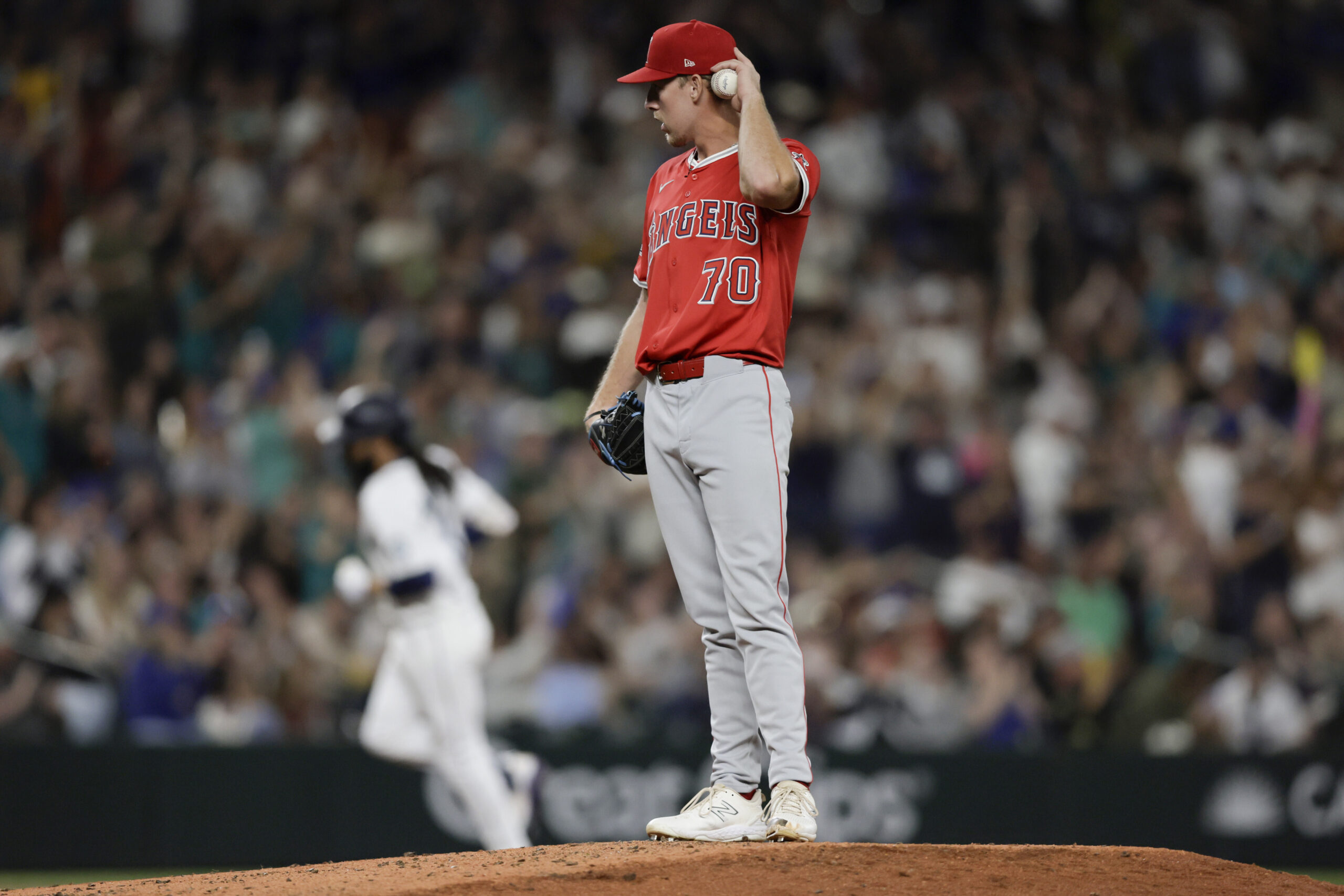 Angels starting pitcher Mitch Farris stands on the mound as...