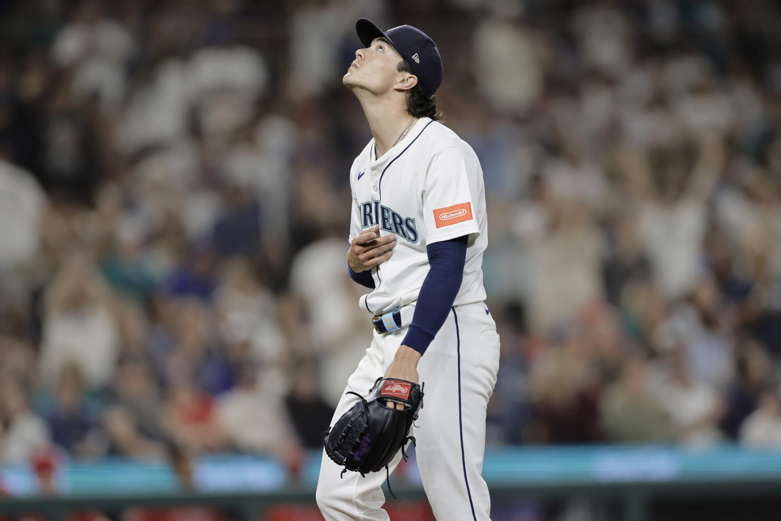 Seattle Mariners starting pitcher Bryan Woo looks up after pitching...