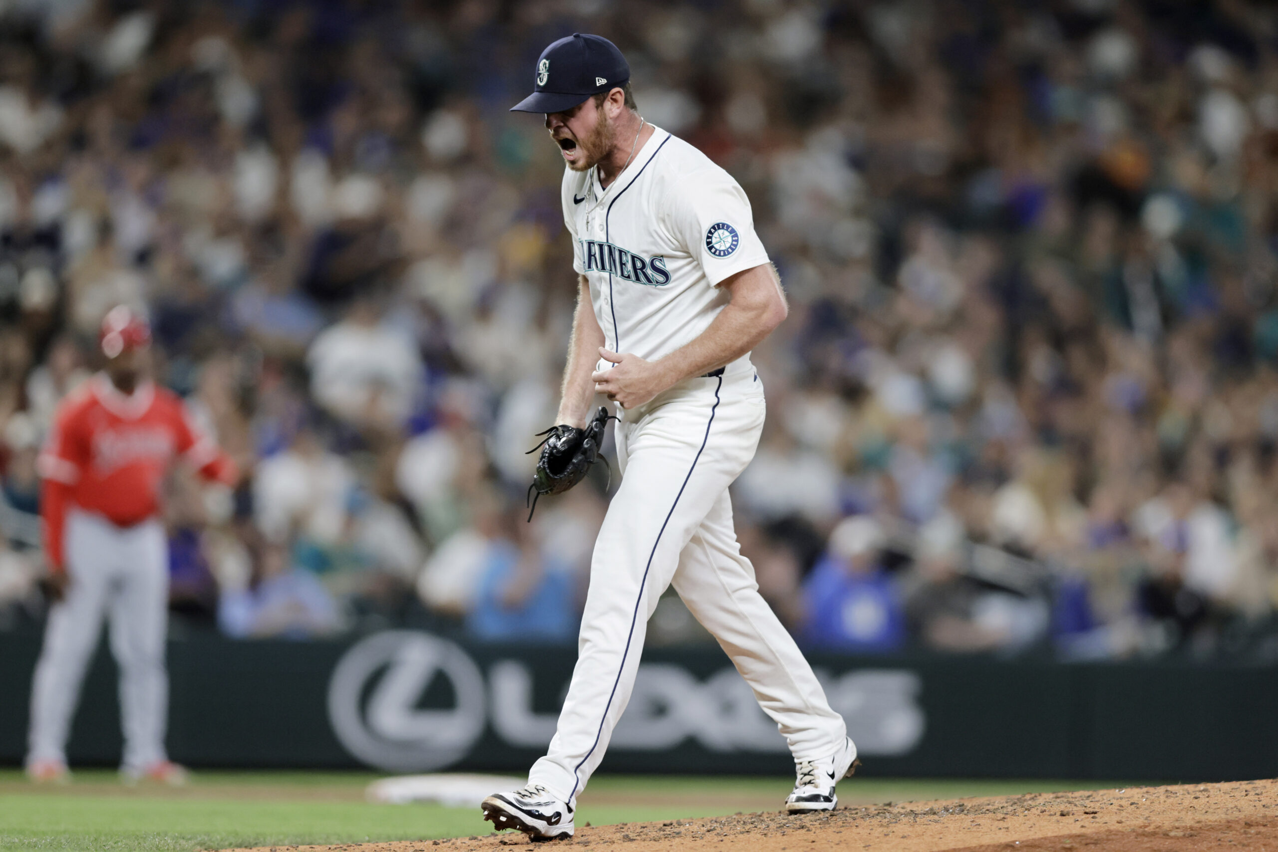 Seattle Mariners pitcher Caleb Ferguson reacts after a strike out...
