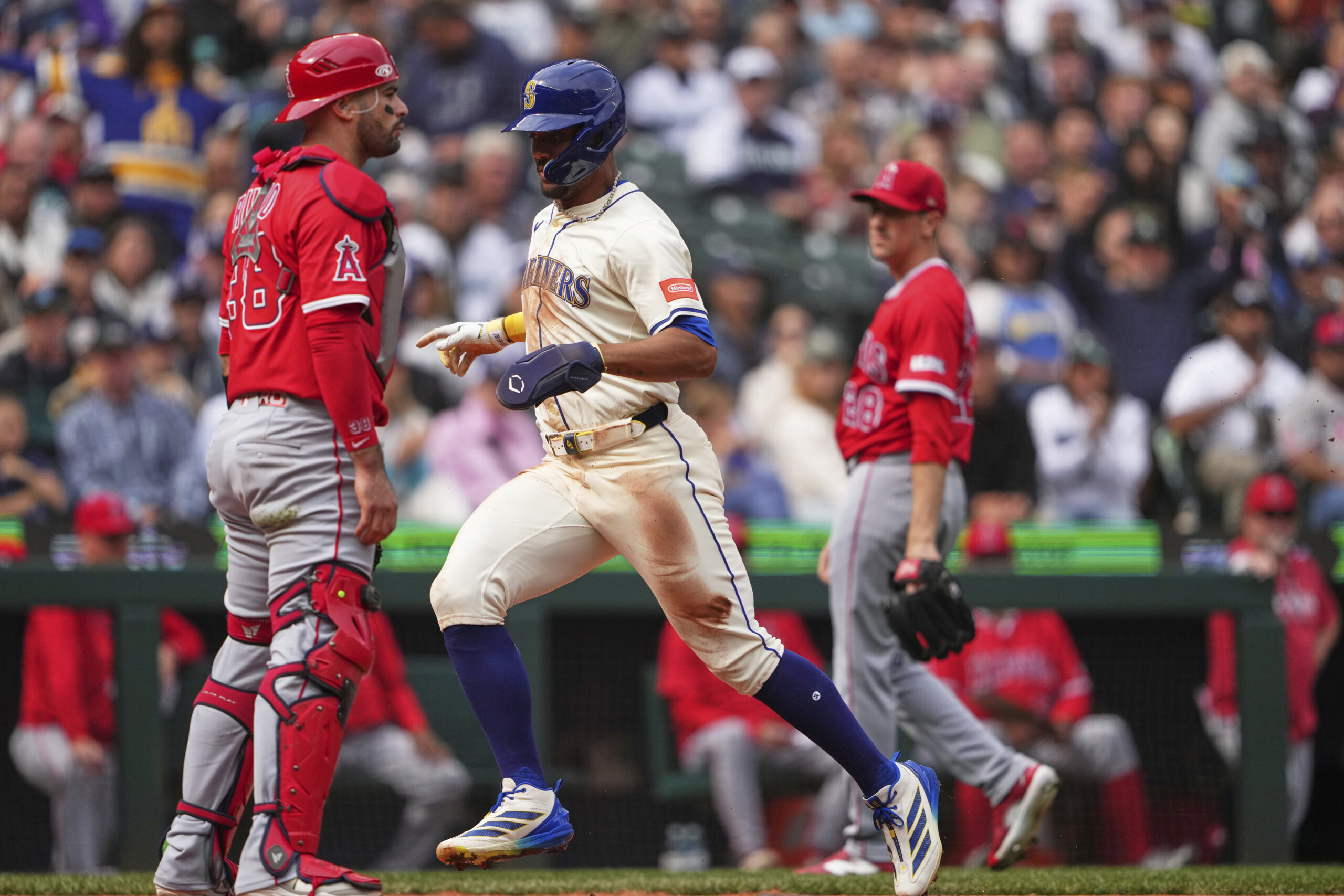 Seattle Mariners’ Julio Rodriguez scores on a sacrifice fly from...