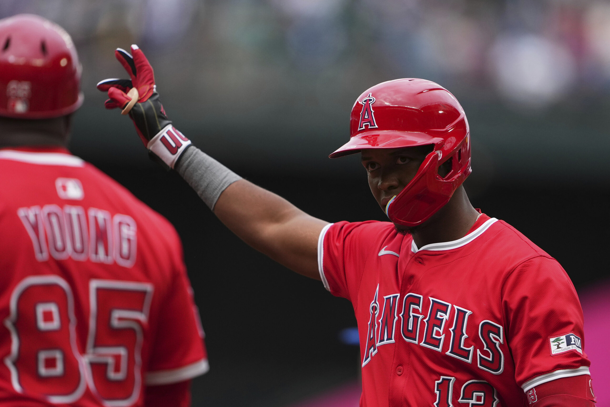 Angels’ Denzer Guzman reacts after his first Major League hit...