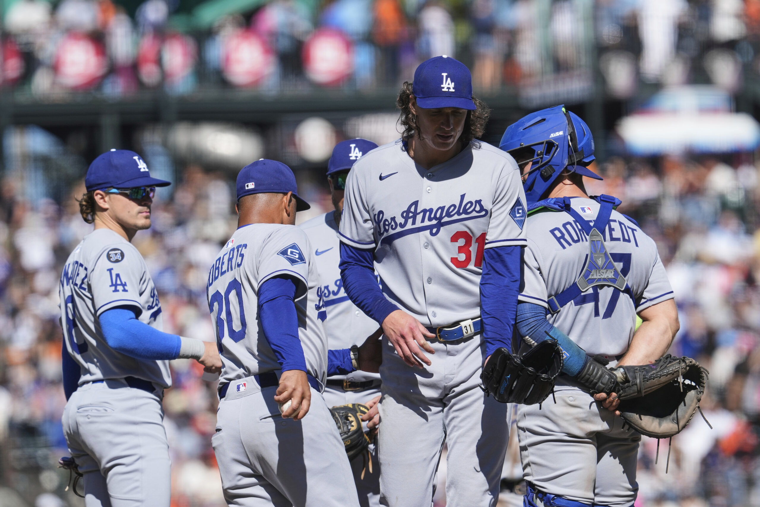 Dodgers pitcher Tyler Glasnow (31) walks past manager Dave Roberts...