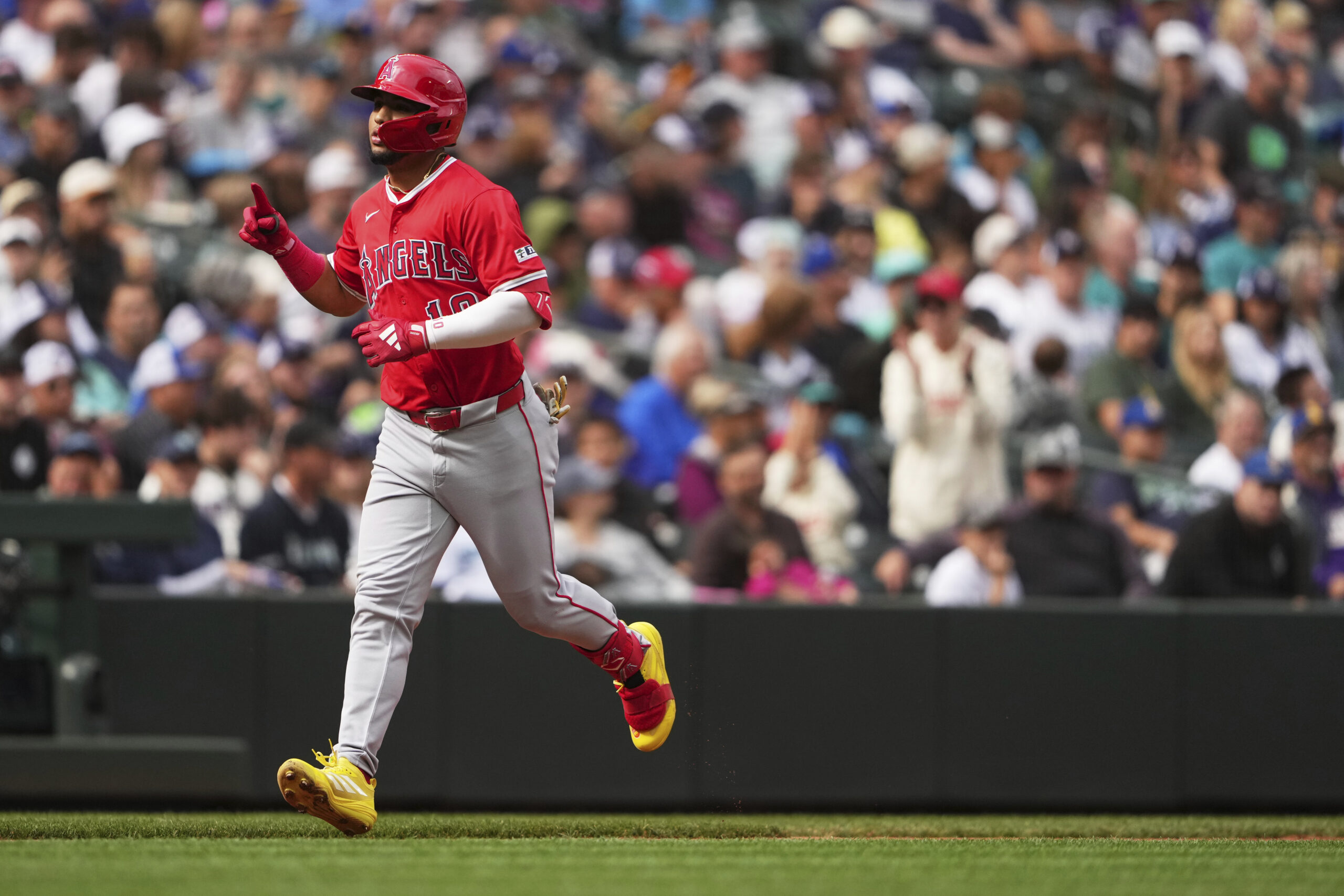 Angels’ Oswald Peraza jogs home after hitting a solo home...