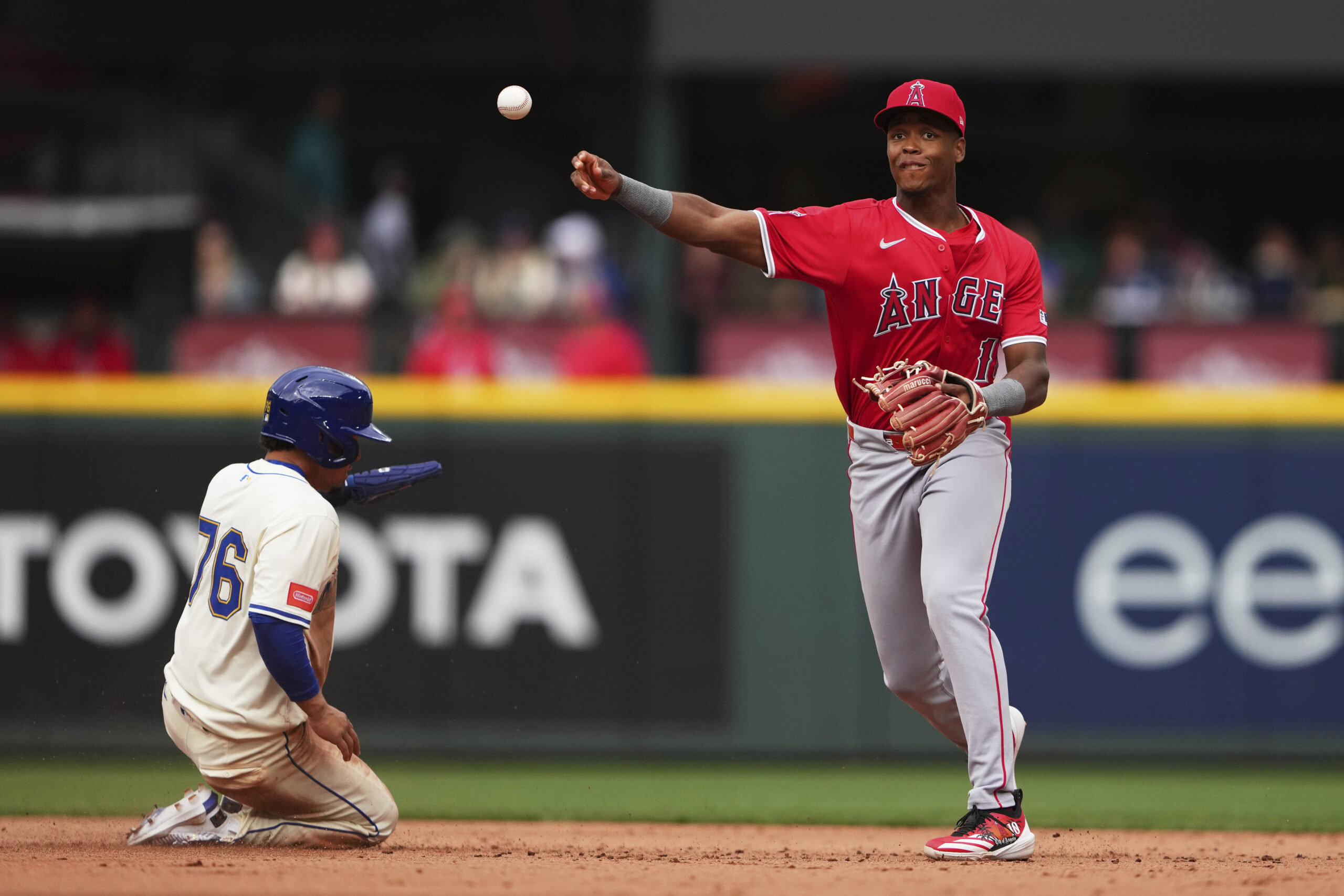 Angels shortstop Denzer Guzman (13) throws to first base for...