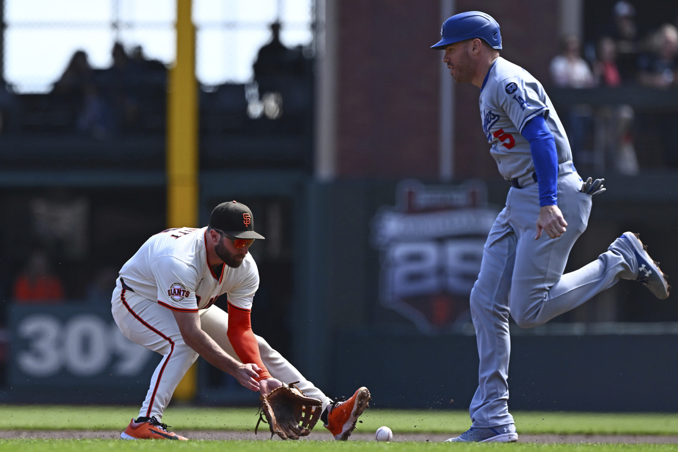 San Francisco Giants’ Casey Schmitt (10) scoops up a grounder...