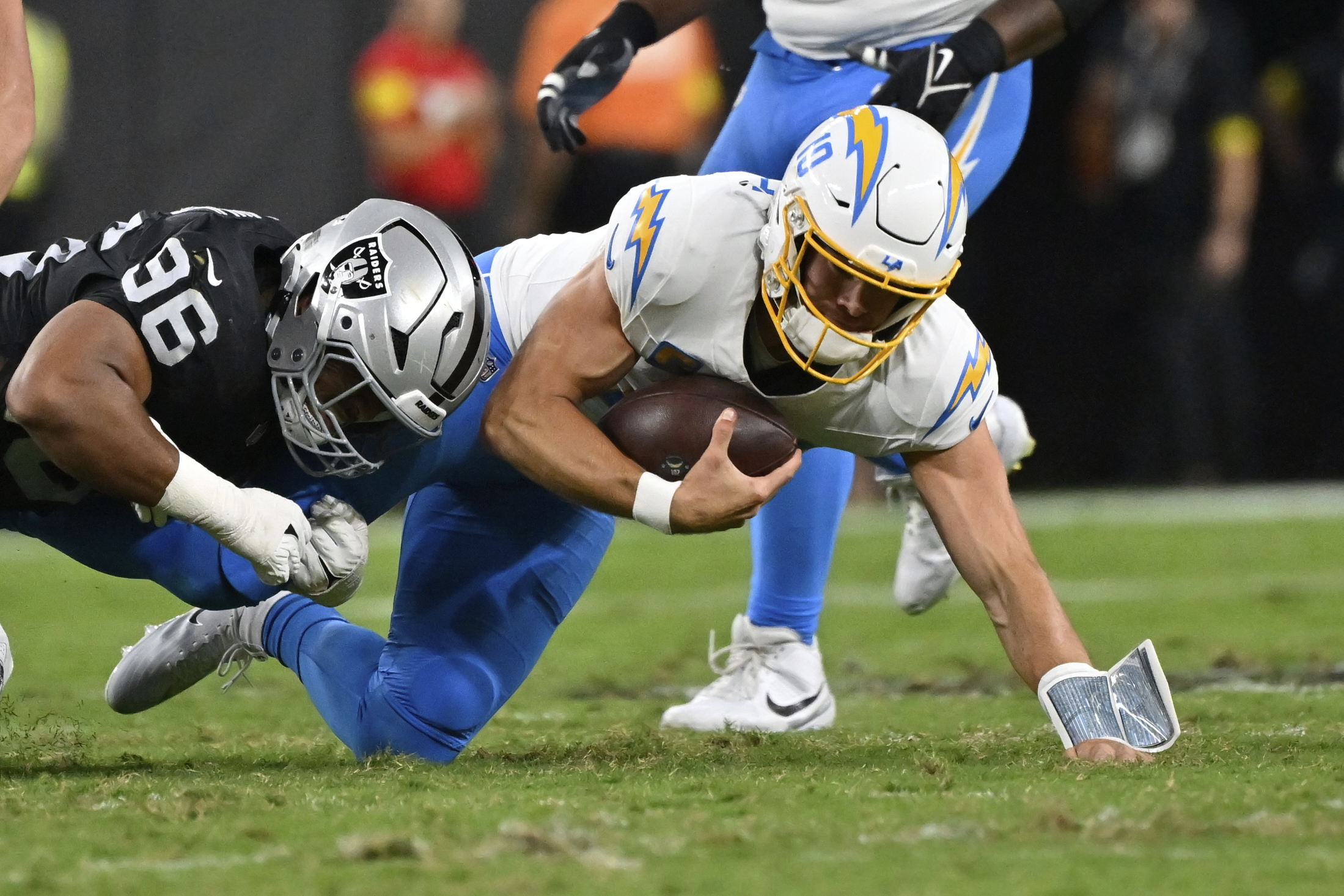 Las Vegas Raiders defensive tackle Jonah Laulu, left, tackles Chargers...