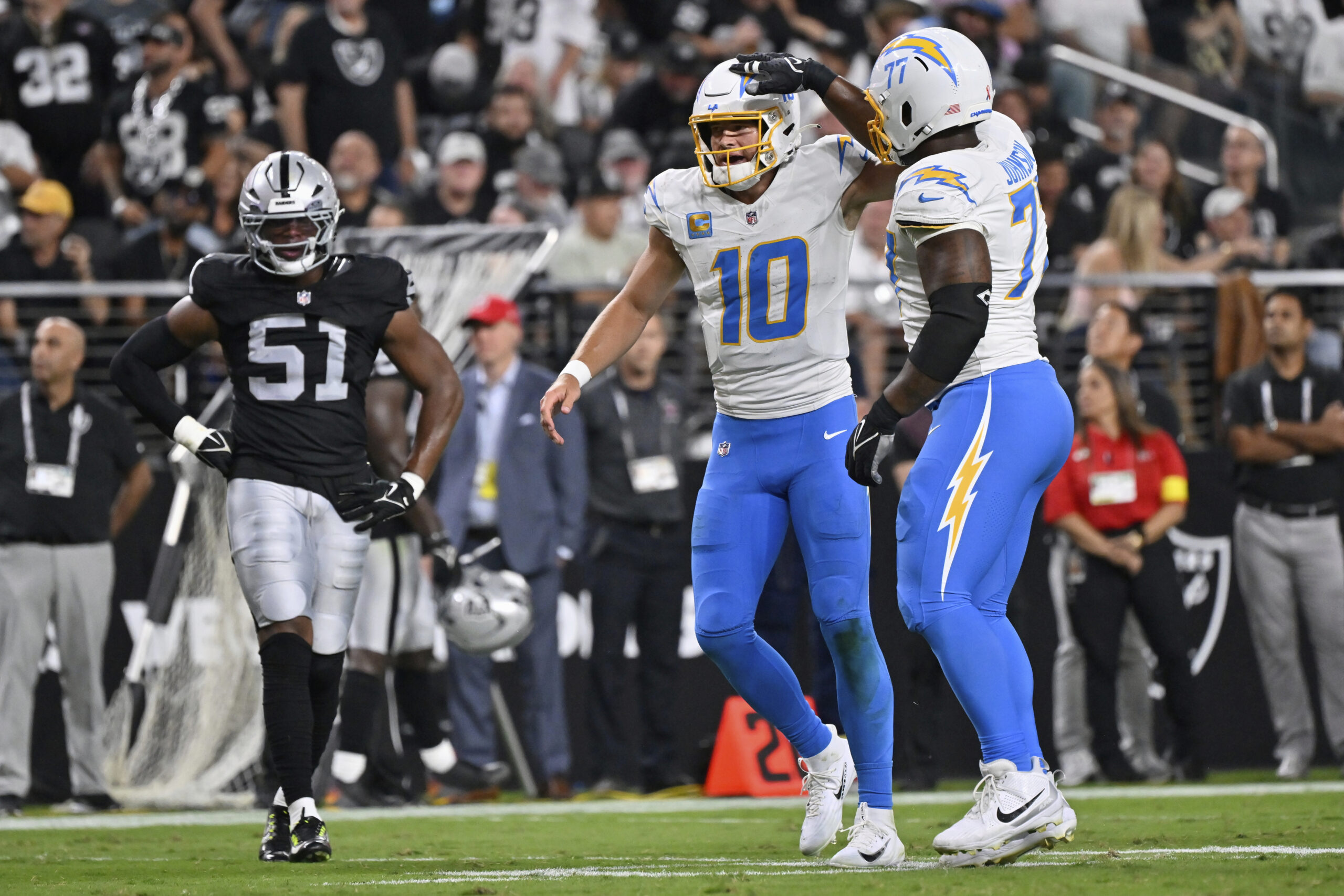 Chargers guard Zion Johnson (77) and quarterback Justin Herbert (10)...
