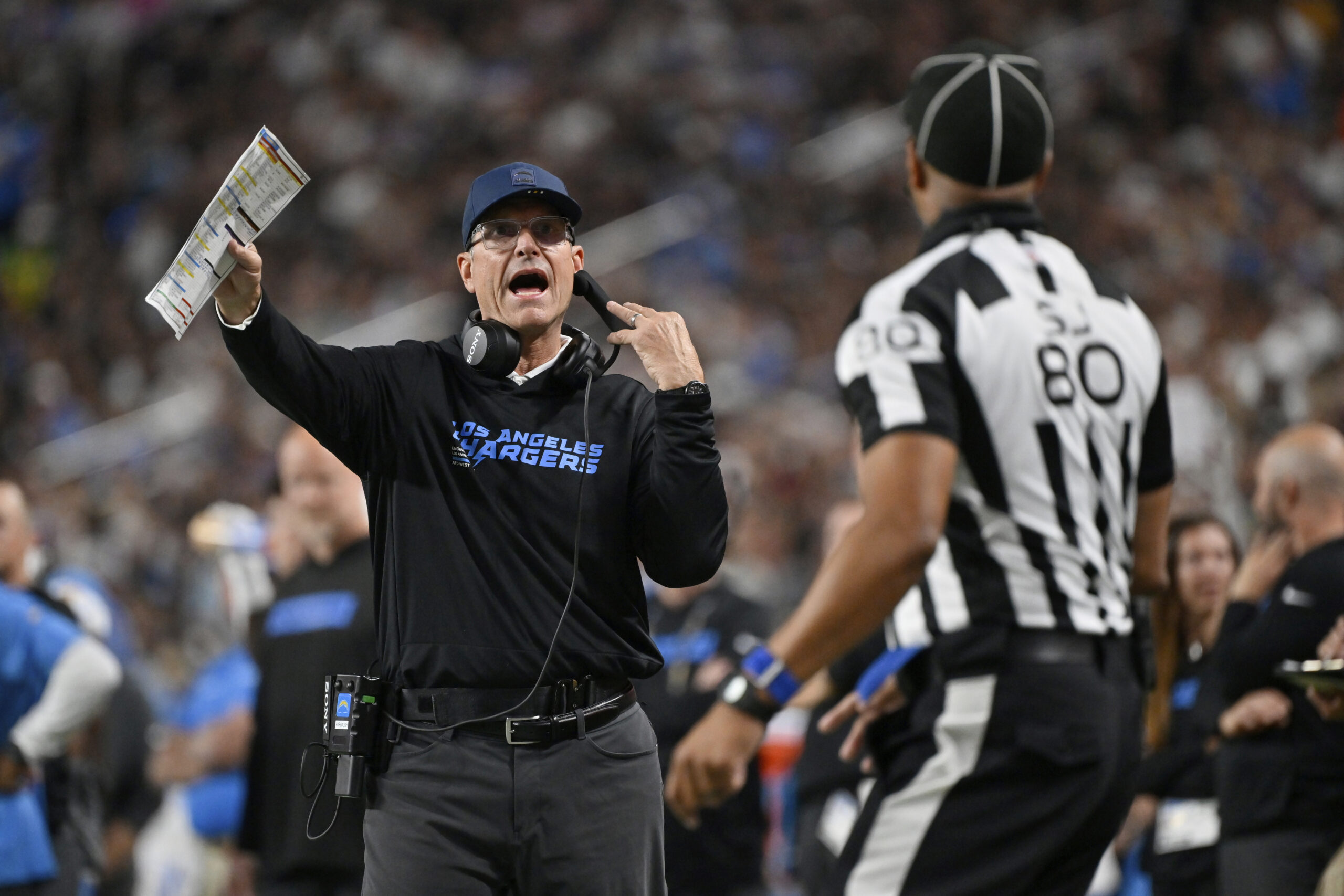 Chargers head coach Jim Harbaugh motions towards an official during...